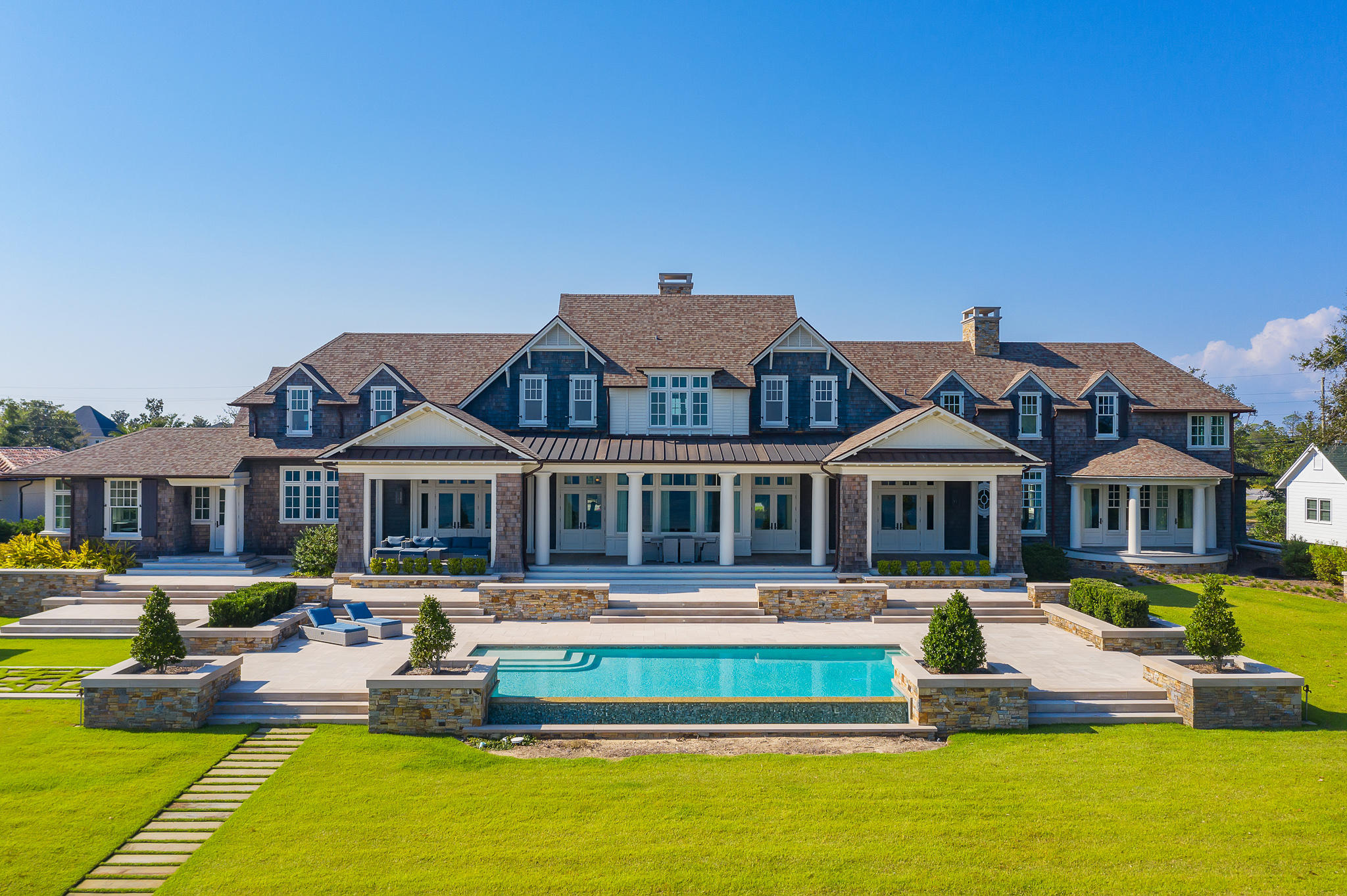 Reigning over 3.1 acres, this impressive Hamptons style edifice sprawls along 200+ feet of Bay frontage framed by both the historic St. Andrews Bay and the lush picturesque vegetation present throughout the estate. A true architectural masterpiece executed by the sought-after architect Eric Watson and builder Clifford C. Myers of Macintosh Myers Construction. The optimal balance of both common and intimate areas is achieved in the 21,000 square feet of highly articulated living space spanning three cohesive levels interconnected by both grand staircases and elevator. The estate is geographically poised within close proximity to the famed Shell Island and Gulf of Mexico pass by boat along with the world-class dining and entertainment venues found throughout inland Panama City Beach and 30A.