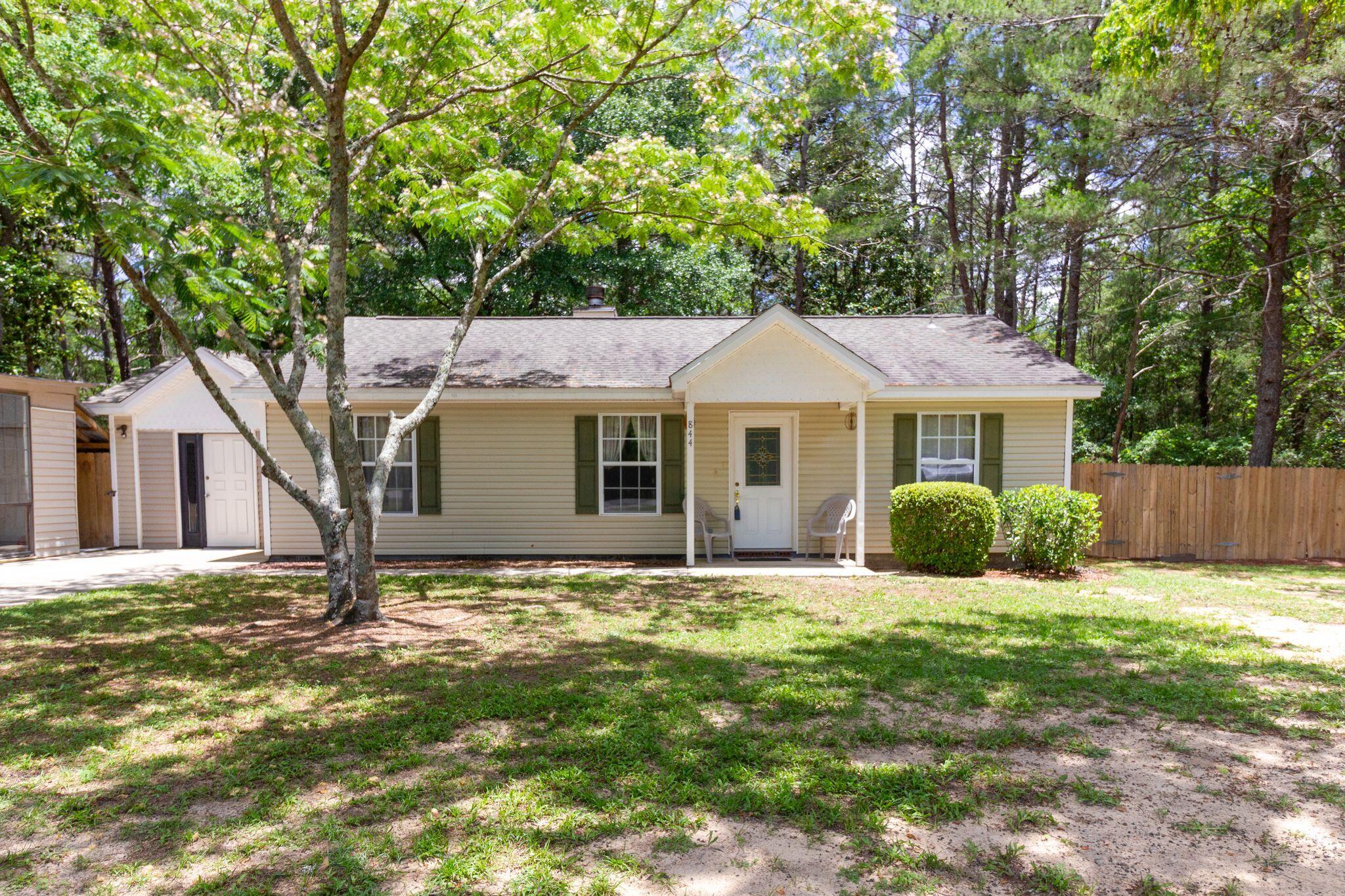 BACK ON THE MARKET THROUGH NO FAULT OF THE SELLER- Welcome to your charming country retreat just outside the city limits! This delightful 3-bedroom, 2-bathroom ranch-style home sits on a spacious 1.25-acre lot, offering ample space for privacy and outdoor activities. The backyard is fenced, but the property extends a long way past the fenced area.As you step inside, you're greeted by a warm and inviting interior, featuring a cozy living room perfect for family gatherings or quiet evenings by the fireplace. The galley kitchen boasts ample cabinet and counter space, modern appliances, and tile backsplash behind the stove and sink, making meal preparation, and clean up, a breeze. The primary bedroom offers a peaceful retreat with an en-suite bath and walk-in closet. The split bedroom design helps add an additional level of privacy. On the other side of the house, there are two additional bedrooms that share a full bath.
Outside, the expansive yard offers endless possibilities for outdoor enjoyment, whether it's gardening, entertaining, or simply soaking in the serene countryside views from your covered back porch. A portion of the property is already partially fenced, ideal for pets or added security. There is even an outbuilding in the backyard perfect for a playhouse, storage or workshop!
Located just outside the city limits, this property offers the perfect blend of rural tranquility and convenience. It's a straight shot to Crestview via Hwy 90, Niceville via Hwy 285 and only 39 minutes to Eglin AFB! Don't miss your opportunity to make this charming country oasis your new home sweet home! Schedule your showing today.