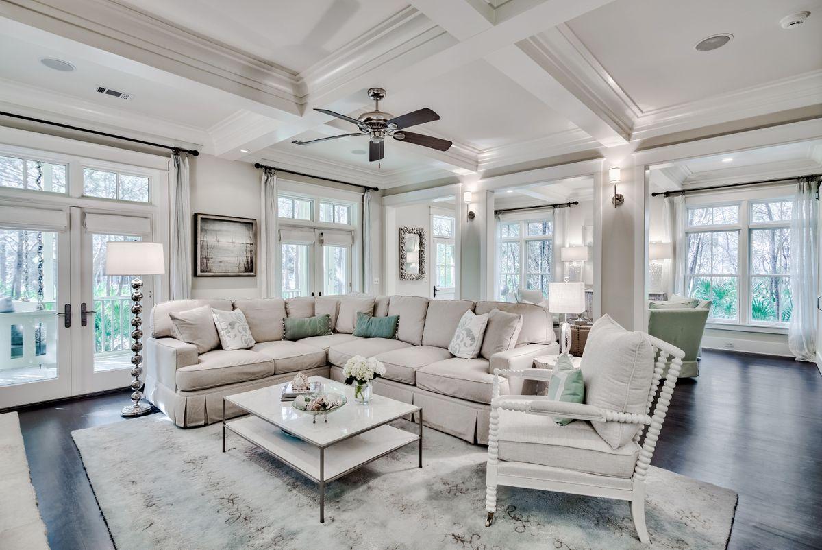 Tucked away in a leafy environment backing up to a stream, this charming beach cottage is rather special. Arranged on three levels with elevator access and topped with a lookout, this exquisite four bedroom home is brimming with architectural features. Updated hardwood flooring sets the tone of quality and comfort, enhanced by fireplaces providing natural focal points in the living room and master suite. The coffered ceiling and built-in display shelving add to the charm of the sitting room. Open the French doors onto the porch and enjoy the pine-scented air and sound of birds as you relax on the swing seat with a newspaper or book. The newly remodeled kitchen with attractive quartz counters, backsplash and lighting will inspire any chef to cook and entertain in style.