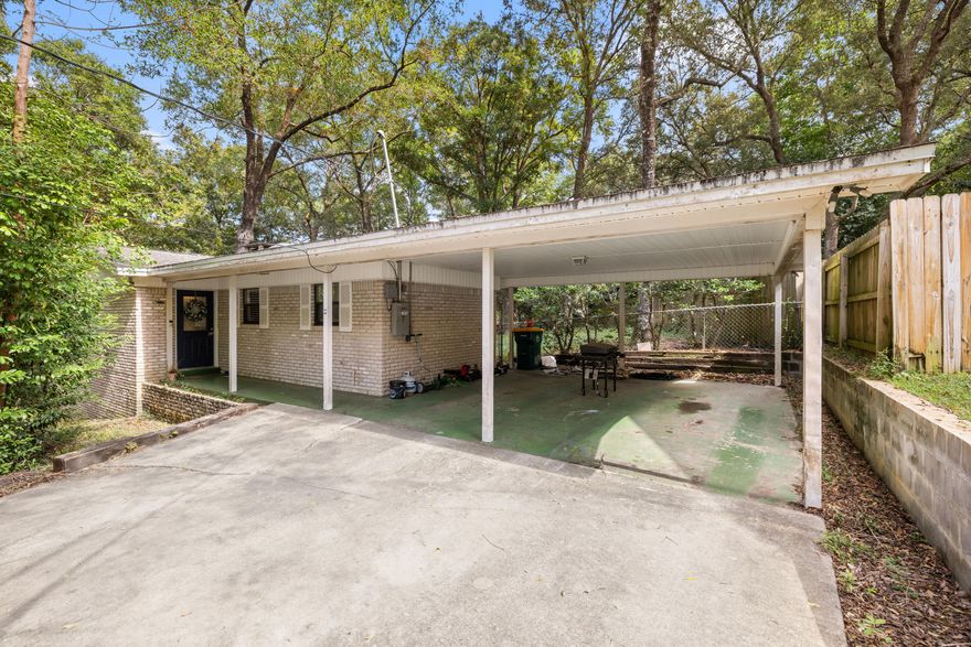 This cozy property in the heart of Niceville is perfect for your first home, next investment property, or empty nest spot! The spacious, open concept kitchen features granite countertops, stainless steel appliances & large breakfast bar.  Both bedrooms are oversized with beautiful wood flooring and the bathrooms have been updated and feature tons of natural light.  The living room boasts a wood-burning fireplace and direct access to a covered, screened-in porch--perfect for enjoying a morning cup of coffee or evening cocktail!  The roof needs replaced and the carport needs to be removed or shortened away from property line so home will not qualify for financing. Cash only.  For photos of interior from previous listing, please visit:https://bit.ly/411Redwood