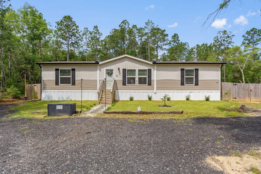 Built in 2022 and exceptionally maintained, this 3-bedroom, 2-bath home sits on a full acre in a peaceful setting surrounded by nature. A spacious horseshoe gravel driveway offers plenty of room for parking and easy pull-through access. Inside, the open-concept layout features a split-bedroom design, recessed lighting, a few Smart WiFi switches, a WiFi-enabled fan, cordless vinyl blinds, and an Ecobee Smart Thermostat. All bedrooms include walk-in closets. The kitchen is outfitted with a custom coffee bar  and nearly new LG French-door fridge & whisper-quiet 3-rack dishwasher. Step out to a 10x16 screened-in back deck with accessible under-deck storage, a cozy Fire-Pit area, 10x12 Shed and a Privacy Fenced yard with Zoysia grass. Other great outdoor upgrades include Govee Permanent Smart Light on the exterior of the home. The outdoor accent lighting, full glass storm door and fiber internet add comfort and convenience to this serene property. Enjoy the summer days in the well maintained 16-ft above-ground pool as it conveys with the home or it can be removed at the buyer's request.