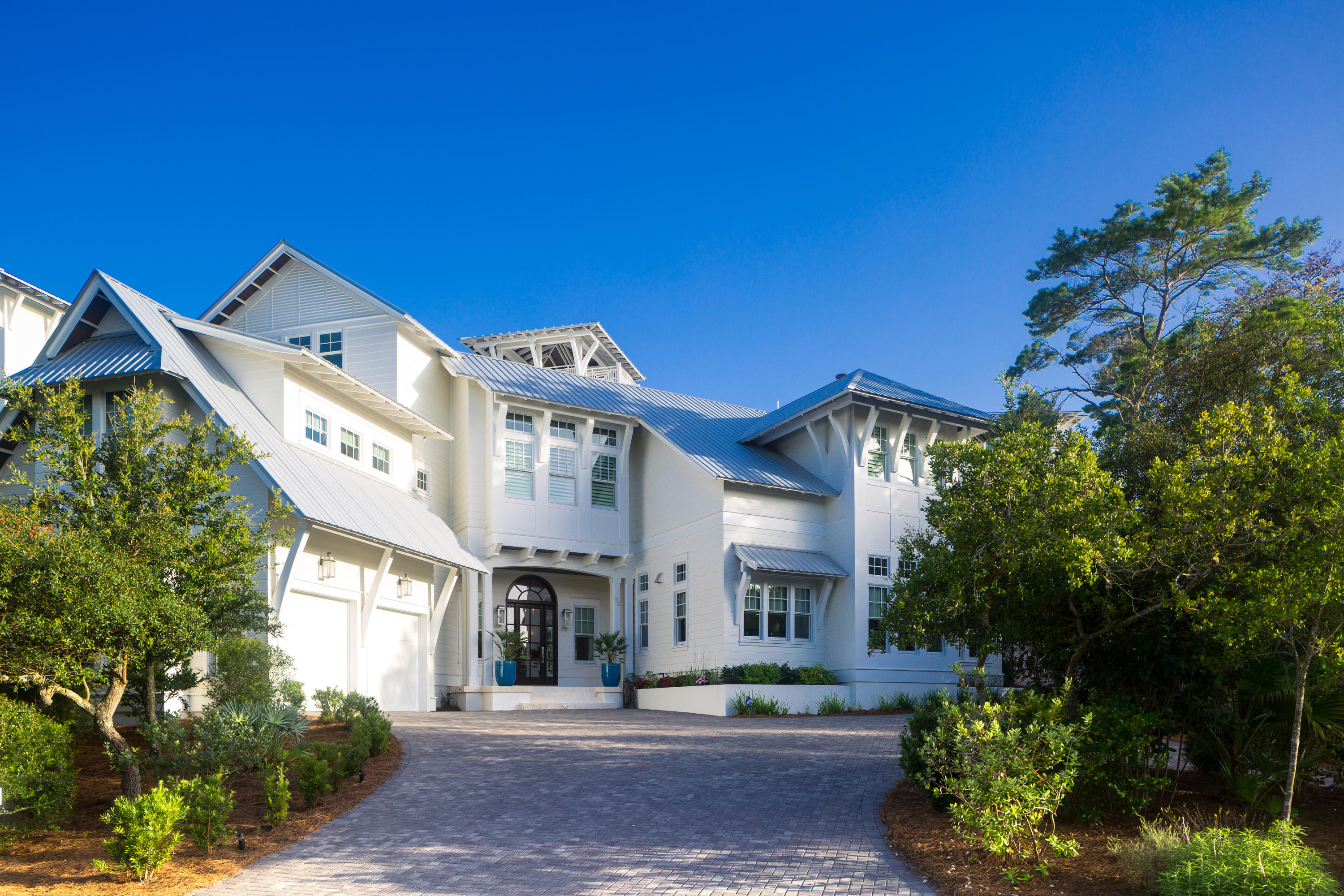 A true sanctuary in a highly coveted location in Old Seagrove, this 5BR/6.5BA Gulf view retreat was custom-built by Alex Rice of Old Seagrove Homes. Private courtyard walls surrounding an outdoor oasis with a gunite saltwater pool, a fire pit and a grilling and dining area creates a peaceful, secluded ambiance yet the beach, Seaside and WaterColor are just steps away. Every detail of this home has been meticulously selected and the quality of materials is evident from the moment you enter the gorgeous Mahogany front door. A chic coastal style creates a bright and sunny vibe where pecky cypress accents contrast with white walls and carefully chosen design features such as a grand tabby shell fireplace in the living room.