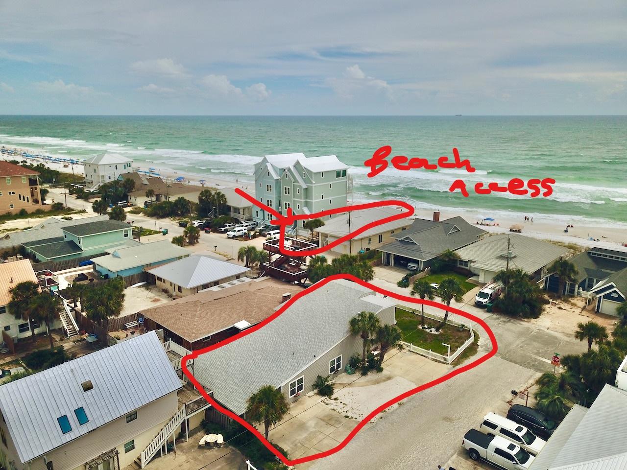 Gulf Views! Great beach house across the street from the sandy white beaches. .Just steps away from being able to take a dip in the emerald waters. The main entry has a beautiful etched glass door. The open living area has 18 ft beamed ceilings and features a wood burning fireplace with stone accents, creating a cozy ambiance. .The kitchen is open to the living room with glass sliding doors opening to the large sun room. The first floor has 4 bedrooms and is all tiled. The bedrooms are connected with Jack and Jill bathrooms, providing an on suite for all. There is a spacious laundry room in the rear of the 2 car carport which is accessible from the doorway exiting the hallway from the bedroom areas. Upstairs is a master suite with a huge jetted tub, a huge walk in closet and a large balcony where you can chill on your Adirondack and take in the Gulf views. The master suite also has a hookup for a stack-able washer and dryer. This house is made of sturdy CBS block construction with hardi board plank siding. There is a cute fenced in yard with a covered area for outdoor dining. The roof was replaced in 2019, the 2 AC's and 2 water heaters replaced in 2018 as well as the fridge, stove and microwave. There is plenty of parking on this property because it is a corner lot and could easily accommodate an RV or boat or several cars, trucks, golf carts, etc. Bring your toys! This property's land use is ''seasonal resort'' so it may legitimately be an Air B and B and available for short term vacation rental. It is presently occupied as a primary home but has been a productive vacation rental in the past.