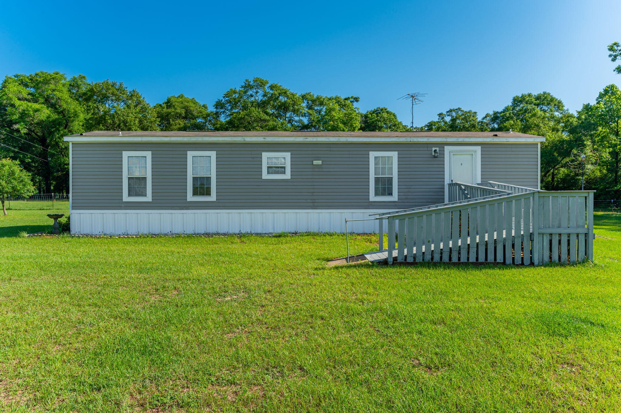 This charming home offers peaceful country living with beautiful views of the surrounding landscape. With 2 bedrooms and 2 bathrooms, the layout is both comfortable and functional. The open living area is filled with natural light, creating a warm and inviting space to relax or entertain. The kitchen provides ample cabinet space and blends perfectly with the home's cozy, rural character. Nestled in a quiet area, the property offers a slower pace and a deeper connection to nature, all while remaining within a reasonable distance of local amenities. Come experience the tranquility and charm of this countryside retreat--contact us today to schedule your showing.