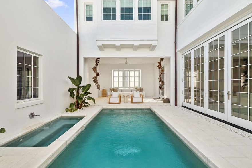 Experience refined coastal living at 53 Portico Lane, a SummerStory Showcase Home in the coveted Kaiya Beach Resort. Thoughtfully featured in collaboration with the nationally acclaimed boutique, SummerStory, this 4,414 sq ft retreat offers 4 bedrooms + bunk and game areas, 5.5 baths, and an inviting bedroom suite on the main level. The home's private courtyard reveals a serene pool, spa, and fully equipped summer kitchen, while interiors feature Wolf and Sub-Zero appliances, Waterworks fixtures, and curated furnishings. Framed by preserve views, every element speaks to timeless elegance and elevated coastal design. Spaces designed for living with generous closets, a flex space on floor two and dual sinks in the ensuite bathrooms. Close proximity to the beach as well as the Watersound Club. 53 Portico offers a location that is convenient for urban living as well as a respite from the hustle and bustle.