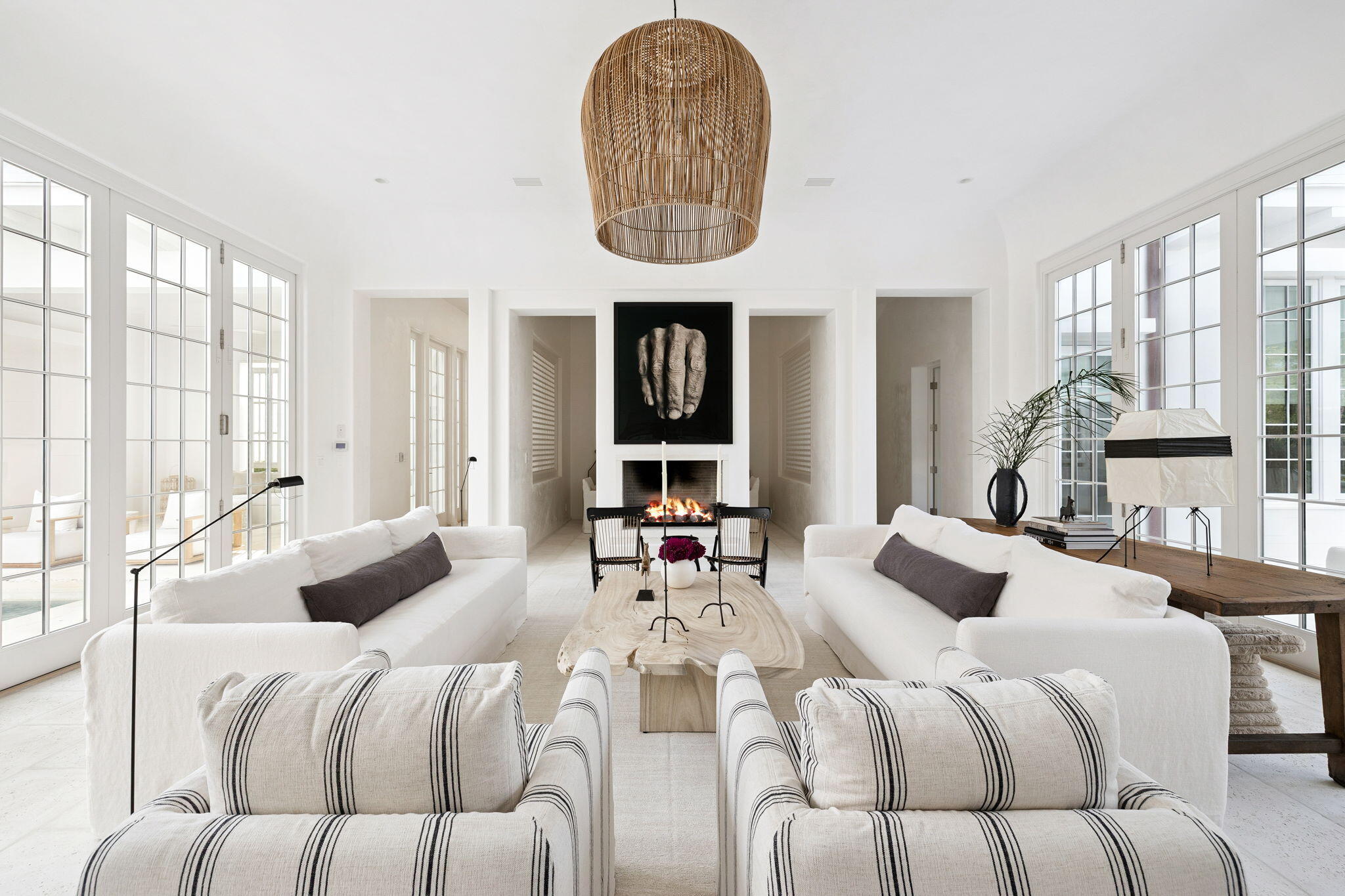 Experience refined coastal living at 53 Portico Lane, a SummerStory Showcase Home in the coveted Kaiya Beach Resort. Thoughtfully furnished in collaboration with the nationally acclaimed boutique, SummerStory, this 4,414 sq ft retreat offers 4 bedrooms + bunk and game areas, 5.5 baths, and an inviting bedroom suite on the main level. The home's private courtyard reveals a serene pool, spa, and fully equipped summer kitchen, while interiors feature Wolf and Sub-Zero appliances, Waterworks fixtures, and curated furnishings. Framed by preserve views, every element speaks to timeless elegance and elevated coastal design.