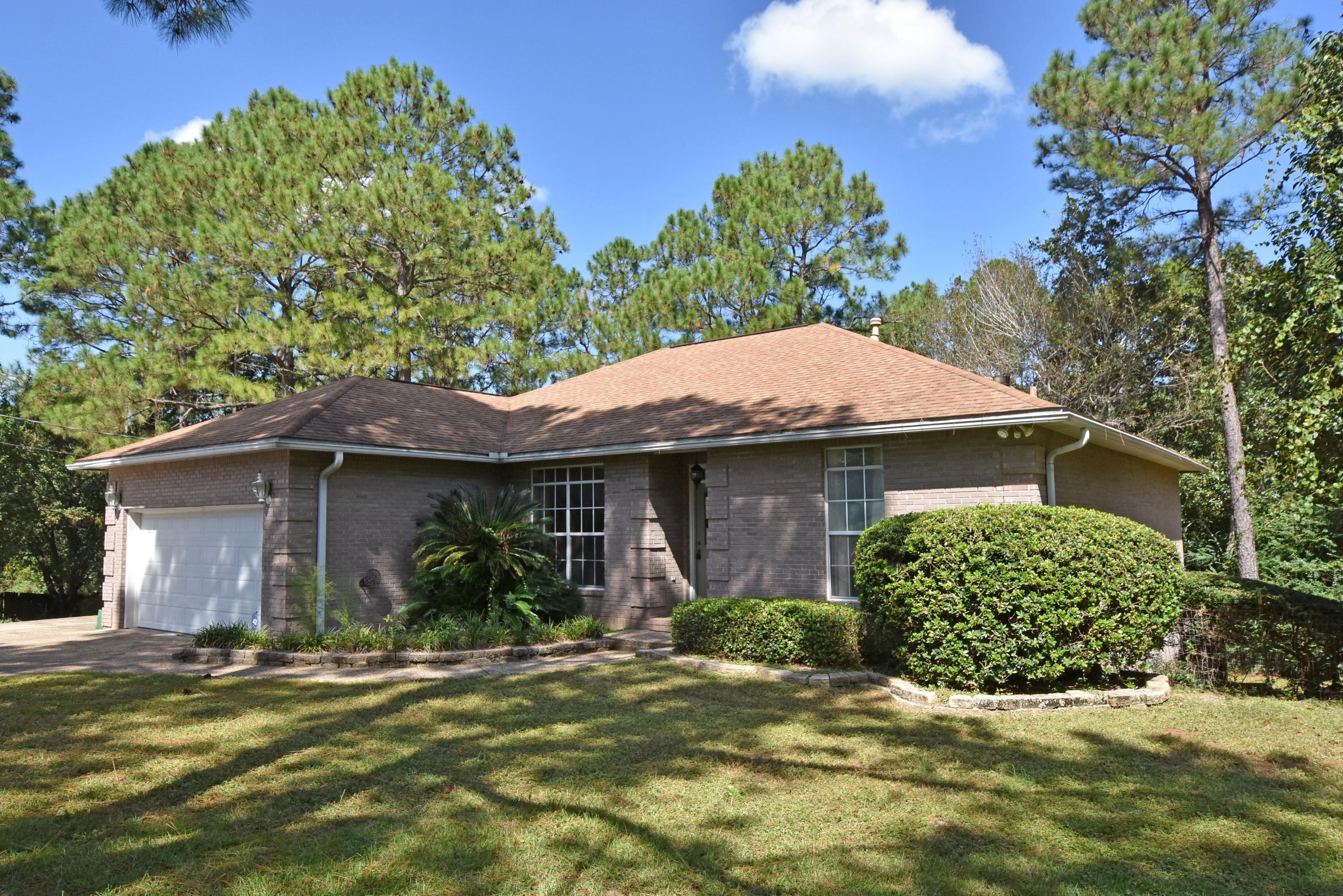 Quiet retreat on 1.86+/- Acres SOUTH of I-10 w/a Greenbelt view from the HUGE Back Deck! EASY to BUY w/1YR Home Warranty and Most Closing Costs paid by Seller! All Brick home w/finished BASEMENT features a Split Bedroom Floor plan w/a PRIVATE Master Suite. Elevated Ceilings throughout w/a triple tray ceiling in the Dining Room and Master Bedroom. Spacious Living Room features a vaulted ceiling, corner gas fireplace and beautiful view of your Wooded Acreage. Kitchen is fully equipped w/all appliances, center island, pantry, Granite Counters, Oak Cabinets and a Breakfast Nook! Access the 12'x24' deck from the Breakfast Nook and stairs to the Full length basement w/rear access. Garage w/work area and utility sink for clean-up in the Laundry Room and Plenty of Storage Cabinets! SEE TODAY!Plus
