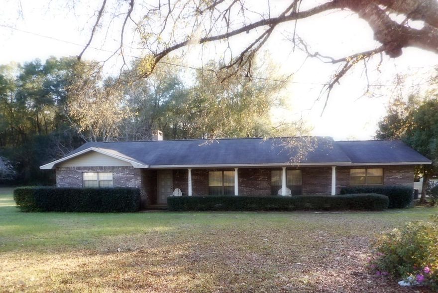 This 2057 SF, masonry home has so much to offer. Not only does it have spacious main residence. It also has a second dwelling on the property previously used as business. It could be mother-in-law quarters or guest house. This second dwelling is 3/2, 1144 SF with 2007 HVAC, and was renovated in 2003. Primary home has a detached 19 x 24 workshop with electric and work bench. Workshop is wired for a generator to run the home in case of emergency. City water and sewer to both homes. All appliances stay with both homes. Primary home has large bedrooms with king size beds in each one. Master bedroom has handicap accessible bath. Split bedroom floor plan. Vaulted ceiling and fireplace in den, formal DR & LR. Two car carport and concrete drive. Paved road frontage. Fruit trees include pear,