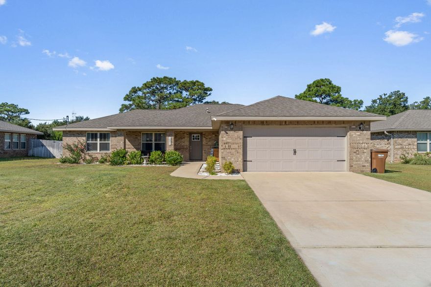Welcome home to this beautiful all brick 4 bedroom, 2 bath home in Gulf Breeze located on a spacious 0.29 acre lot with a fully fenced in backyard (no HOA)! Complete with stunning finishes you'll love this 2019 open floor plan home. Pull up into the driveway and appreciate the landscaping, and walk past the covered front porch to a spacious interior. The nice sized living room is open to the dining space which leads to the well appointed kitchen featuring granite countertops, stainless appliances, drop down pendant lighting, and a walk in pantry. The master bedroom is a retreat with a trey ceiling with crown molding and a fully updated bathroom showcasing double vanities with granite counters and a soaking garden tub with a tiled surround. The split floor plan has three other nice sized