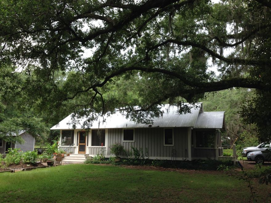 Beautiful wooded lot in Historic Point Washington with massive oak trees creating a beautiful canopy over the property. Charming cottage with an attention to detail. Hardwood flooring throughout. Custom kitchen and bathroom cabinetry with concrete counters in bath and marble in kitchen. Large walk in pantry with stacked washer and dryer. Larger master bedroom with vaulted ceilings and private screen porch overlooking the grounds and gardens. This is a very short drive to the beach and walking distance to the bay and Eden Gardens. This is 2 identical size lots next to each other. Build your main house on the lot next door and this charming cottage can be your carriage house. Don't miss this rare opportunity to own in Historic Point Washington