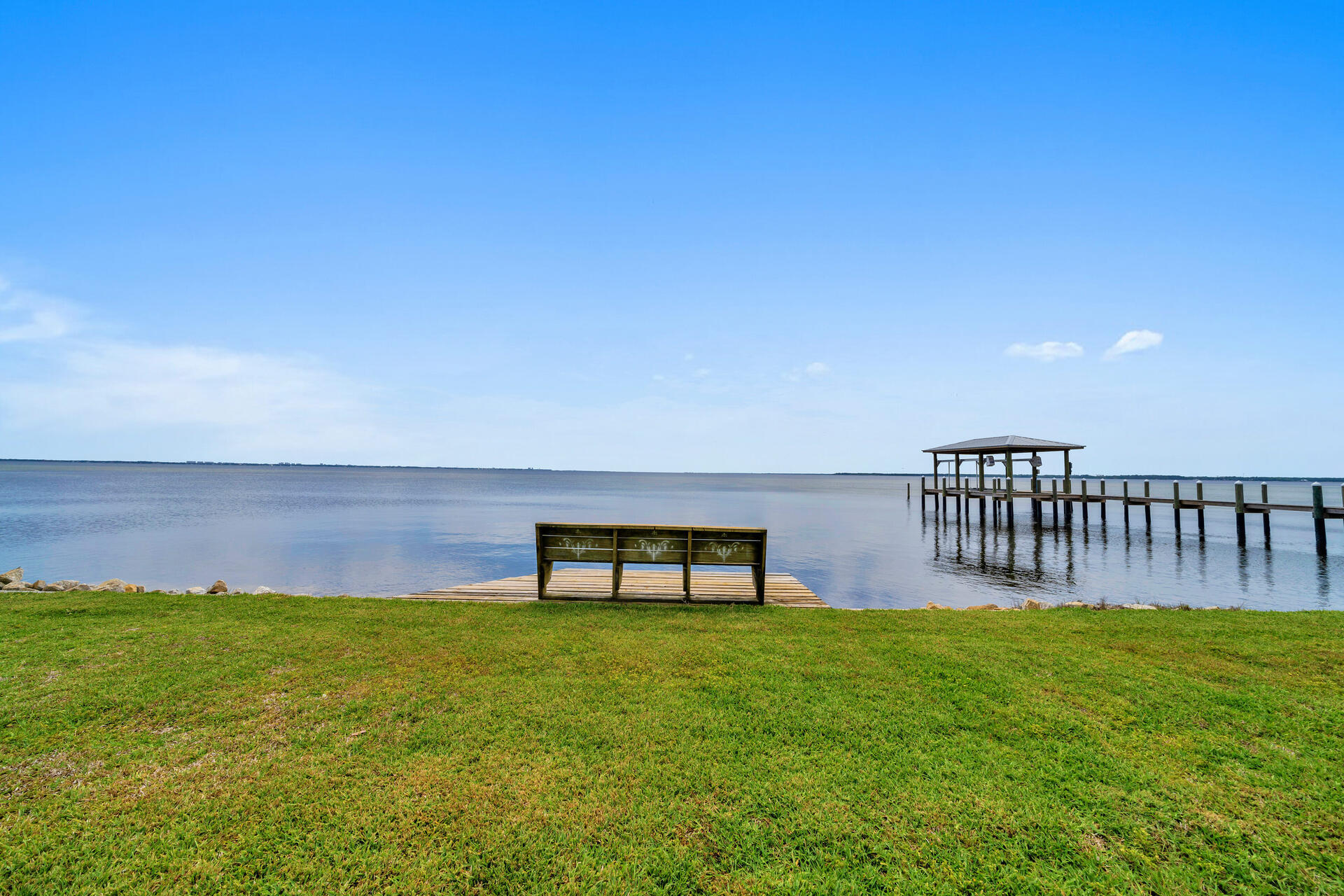 STUNNING custom built Gary Miller home in the gated community of Southwind in Bluewater Bay. This one owner home was thoughtfully designed to capture the amazing panoramic views of Choctawhatchee Bay from nearly every room. The open floorplan seamlessly flows from one room to the next while still offering separate living areas for the entire family to enjoy. The living room and dining room are accented with graceful columns and the family room offers plenty of built in cabinetry and a beautiful fireplace. The kitchen is a chefs delight with a gas stove, double oven, center island, marble counters and beautiful white cabinetry. All of these rooms have INCREDIBLE views of the bay through the glass doors along the rear of the home. The master suite is oversized and has a private entry to a