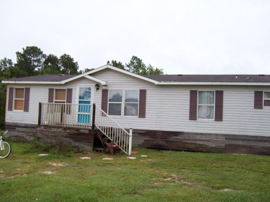 Great location in good neighborhood only 5 minutes from Walmart. Large 4 bedroom 2 bath doublewide on over an acre on a paved road. The home has many updates and features granite countertops, new floor coverings and new paint, 2 living areas, large kitchen, huge master bath, fireplace, and large back deck and storage building.