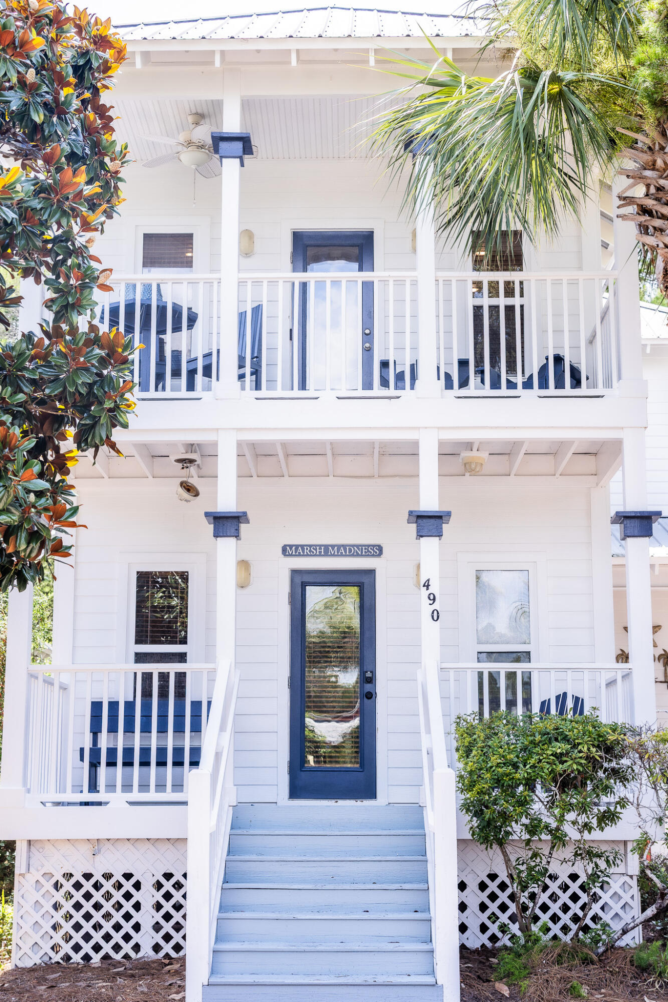 Tucked into the gated community Old Florida Village -- and just across the street from a community pool -- 490 Hidden Lake Way is a classic coastal cottage just a short walk or bike ride from Blue Mountain Beach's dining + shopping favorites. Thoughtfully designed for beach living, the home offers an outdoor shower, French doors opening to two separate porches, and a backyard dining space. Inside, a reverse floor plan and open-concept layout lend itself to gathering around the kitchen, which features granite countertops, stainless appliances, and beadboard cabinetry. The four bedrooms -- including a primary bedroom which features an ensuite bathroom -- are well curated for comfortable stays. Offered full-furnished, 490 Hidden Lake Way is a turnkey investment or vacation opportunity.