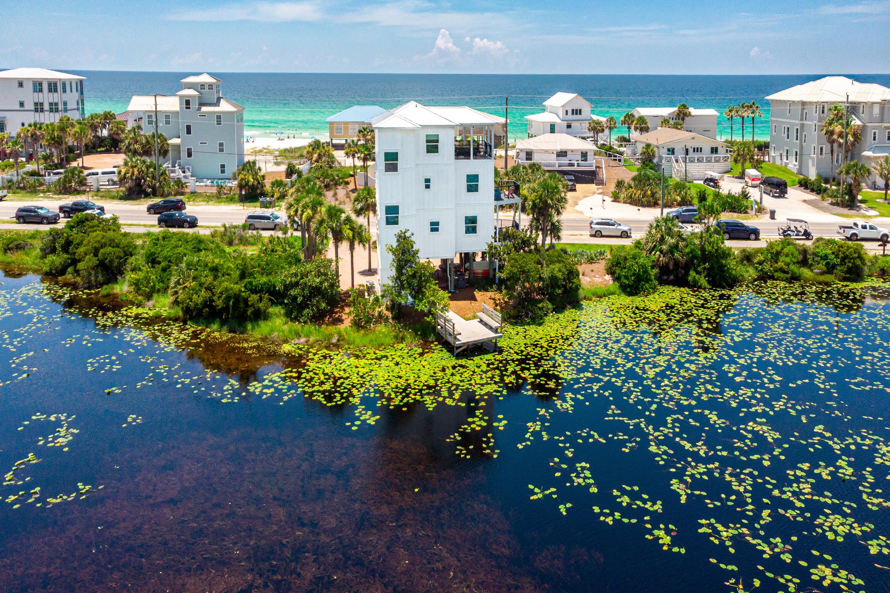 3-Bed, 4-Bath Beach Home on Rare Coastal Dune Lake with Dock and Gulf Views on 30A - Expansive Gulf and Coastal Dune Lake views define this three-story 3BR/4BA beach home with 2,071 sq ft of living space and 330 feet of rare coastal dune lake frontage along 30A. Panoramic water views from nearly every room and balcony create a serene coastal backdrop, ideal for full-time living, a second home, or a high-performing vacation rental.Recent updates within the past year include a new metal roof, windows, Hardie-board exterior, fresh paint, and quartz countertops, providing modern comfort and peace of mind. The top-floor primary suite features a private balcony that overlooks the rare coastal dune lake with views of the Gulf. A private dock allows for kayaking, paddleboarding, and fishing, with easy lake access and an outdoor shower for rinsing off after a day on the water. Inside, you'll find hardwood and tile floors, crown molding, a wet bar, a breakfast bar, and spacious balconies perfect for enjoying breezes and sunsets.
Located across from public beach access and steps from Stinky's Fish Camp, this Dune Allen Beach property offers proximity to Gulf Place, Topsail Hill Preserve, and all the dining, shopping, and recreation Santa Rosa Beach has to offer. No HOA and ample parking on a 0.30-acre lot add flexibility for owners and investors.
This rare property offers both beach and lake access along 30A, blending natural beauty with modern updates in one of South Walton's most desirable locations.