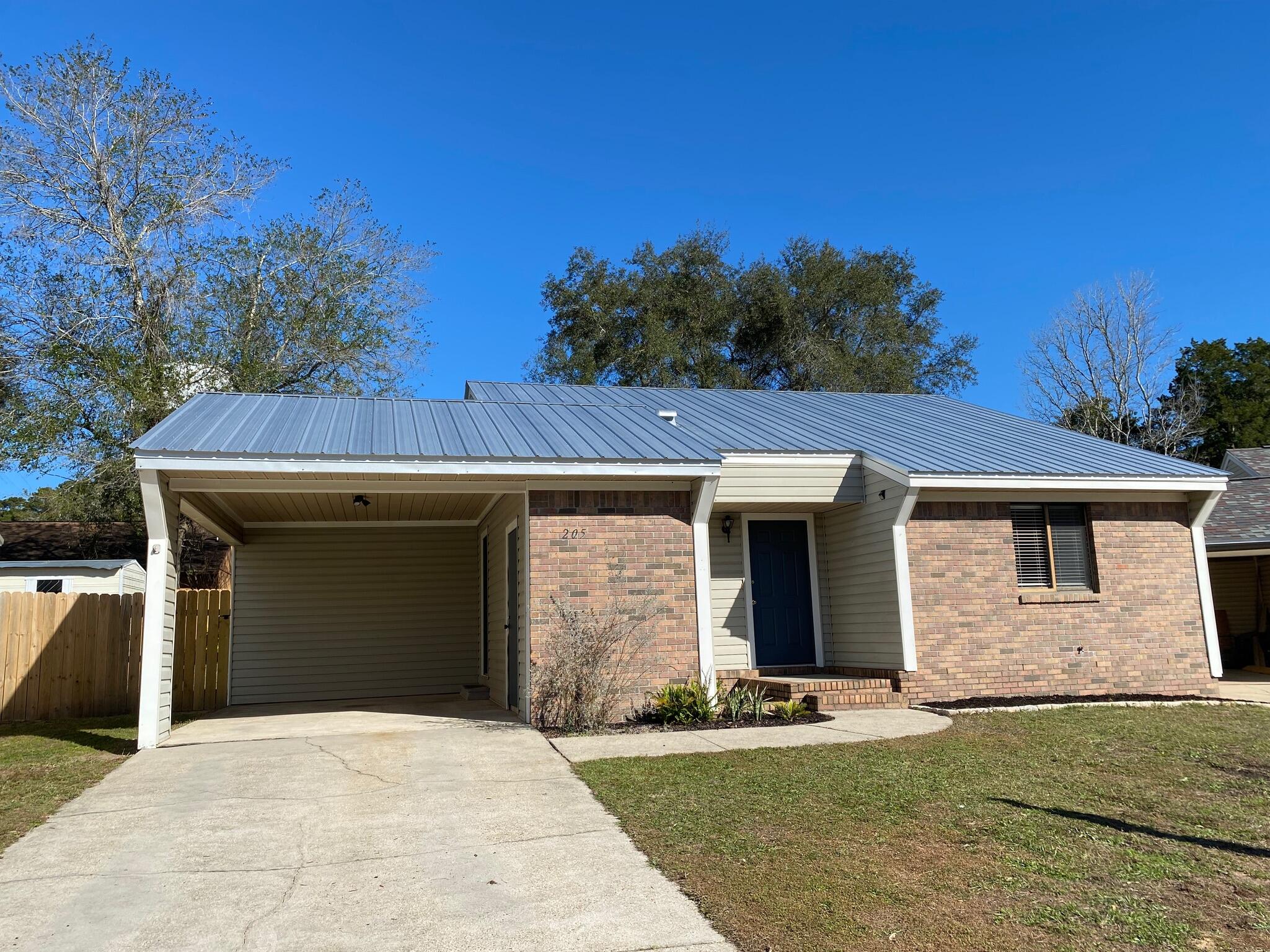 Move-in ready home on cul-de-sac in a great location, close to Northwest Florida State College as well as Eglin AFB & Duke. The open concept home features high ceilings, beautiful natural light and a brick fireplace in the living room with 2 sets of sliding glass doors that lead into the large fenced, private back yard. Adorable galley kitchen with all appliances. 2 Bedroom - 2 full Bath , no carpet, tile throughout. Freshly painted throughout. Wood burning fireplace. Large laundry room. Outdoor storage room off carport area. Beautiful metal roof. Come see this amazing home today!