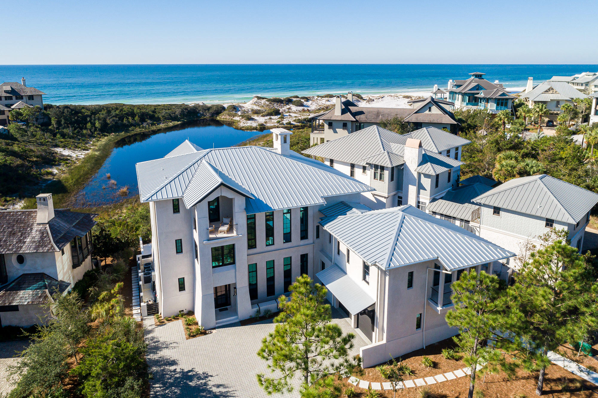 Introducing a true legacy home, poised on a uniquely special, coastal dune lake-front site within The Retreat. This impressive, newly constructed, private lake-front luxury residence, overlooks Draper Lake and the Gulf of Mexico.  Precise attention to design and construction detail has been given by acclaimed architect Matt Savoie and reputable builder Buster Woodruff in creating one of the most majestic residences among South Walton's scenic paradise. The home conveys fully furnished, with interiors just recently appointed by interior designer Georgia Carlee. A coastal retreat for the ages with four spacious levels encompassing 7 bedrooms, 8 full bathrooms and 3 half bathrooms. This home presents a timeless style of comfortable elegance & spaciousness with just under 7,000 square feet of