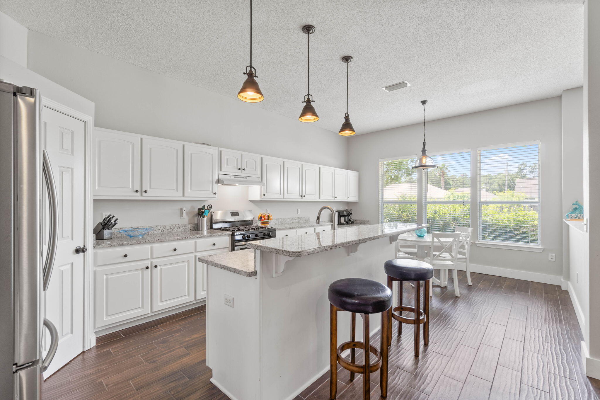 Welcome home to this conveniently located east Navarre home around the corner from the Navarre Youth Sports Association and Navarre High School, just minutes to Navarre's beautiful beaches, and a short commute to Hurlburt Field! Have peace of mind with a new HVAC just installed June 2024, a new roof November 2022, and a water heater replaced in 2020. No flood insurance required and no HOA! Pull up in the driveway and appreciate the well cared for landscaping guiding you to the covered front porch and updated craftsman style front door. Enter inside and you will fall in love with this massive open floor plan with stunning wood look tile extended throughout all the common areas with updated baseboards and soaring ceilings. In addition to a massive living room there's also an open formal