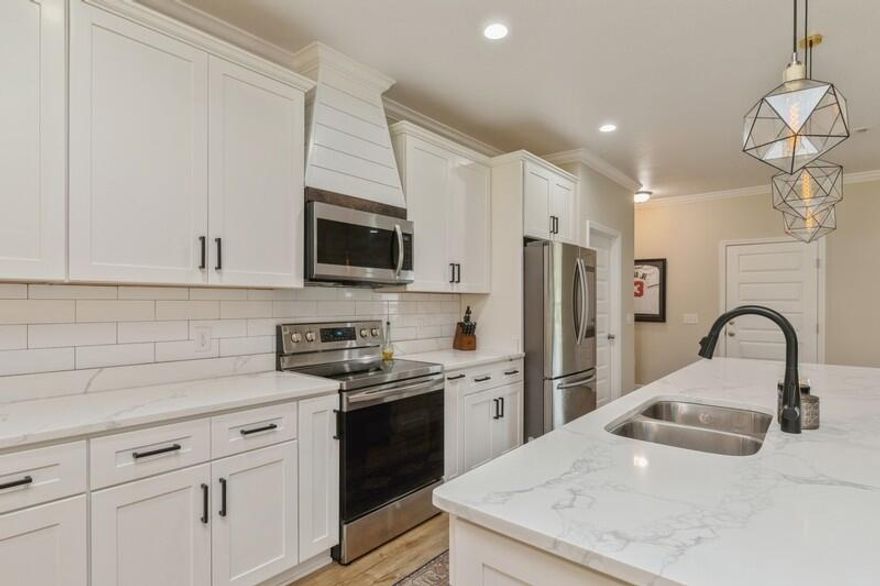 OPEN HOUSE this Saturday 5/6 from 9-12. Stop by and take a tour of this lovely home! Welcome to this beautiful home built in 2020! As you step inside, you'll immediately notice the stunning wood flooring that flows throughout the entire home, providing both durability and style. The open floor plan creates a spacious and inviting atmosphere, perfect for entertaining guests or enjoying time with your loved ones. The highlight of the home is undoubtedly the beautiful all-white kitchen, and massive island with shiplap, sure to impress any cooking enthusiast. With its sleek modern design and top-of-the-line appliances, you'll feel like a chef in your own home. The rustic touches throughout the home add a charming character to the space, and blend seamlessly with the modern design elements. The home features four spacious bedrooms and two bathrooms, providing ample space for loved ones and guests alike. The large tiled walk-in shower in the master bathroom is the perfect place to unwind after a long day. Overall, this home is a beautiful blend of modern design and rustic touches. The stunning wood flooring, all-white kitchen, and open floor plan are sure to make you fall in love with this space. NO HOA! Call and schedule your showing today!