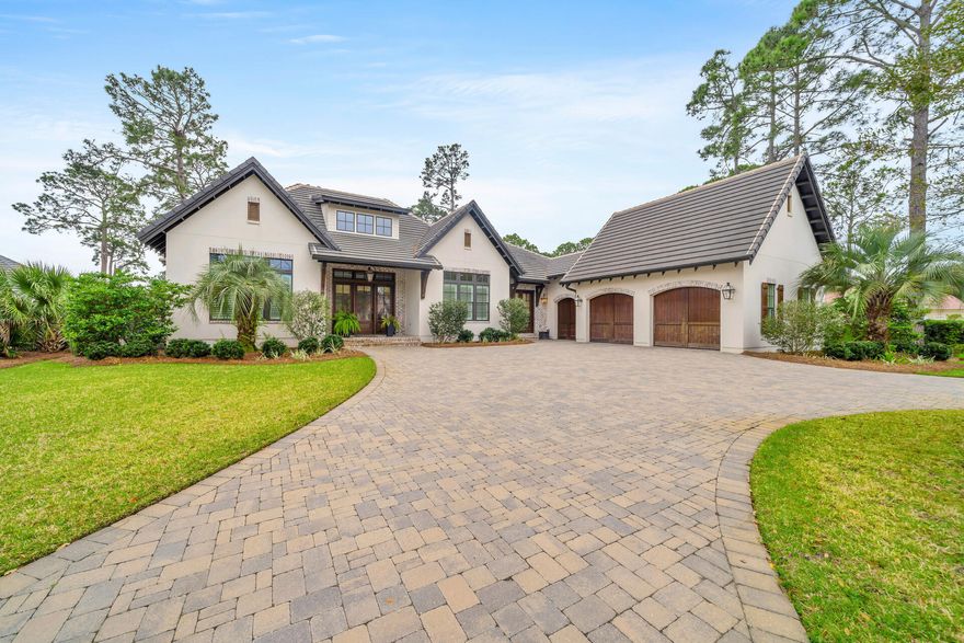Sitting on a generous half-acre lot, this majestic home presides over stunning views of the private pool, lake and Sandestin's Raven Golf Course. Completed in 2018, the home presents like new delivering an unparalleled combination of luxury and comfort in peaceful natural surroundings. The paved driveway makes a suitably grand impression as it sweeps up to the main entrance with a two-car plus golf cart garage to one side. Step inside to appreciate the fine architectural features of this home that add rustic charm through exposed brick, wood beams and a sliding barn door. Expansive living starts in the grand open living room with a dining area that has entertaining uppermost in mind. It adjoins a spacious chef-grade kitchen with quartz countertops, Wolf and Sub-Zero