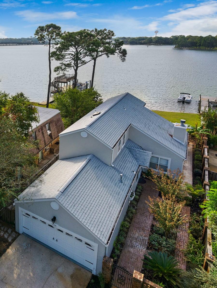 Protected waterfront home on beautiful Cinco Bayou. Gorgeous remodel w/ new high-end appointments, needs absolutely nothing! This 2-story home features a bright, open floorplan w/ a beach flair! Easy access to Choctawhatchee Bay & 15 min boat/jetski ride to Crab Island, Destin Pass, & Gulf. Newly renovated shared dock (2016) w/ deep water (5ft deep at end of dock during low tide)mooring. Renovated Kitchen features include: stainless steel Kenmore Elite appliances, Kohler apron sink, downdraft vented gas cooktop, double ovens, marble countertops, custom island, recessed lighting & is open to the living & dining rooms with workstation water views. Living Rm offers a gas fireplace, new custom built-in floor to ceiling book/display cases. The living room also features a multiple glass paneled