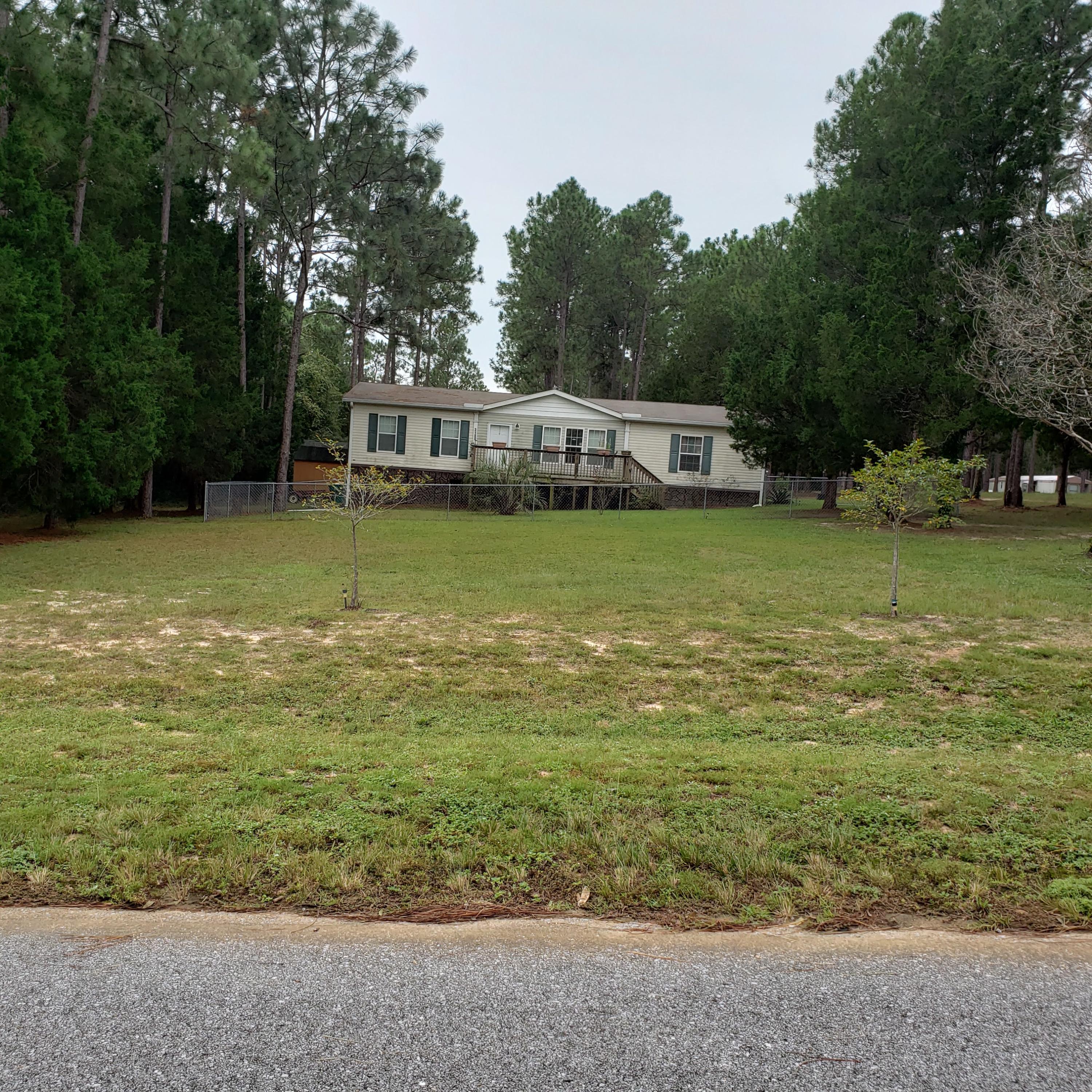 Just minutes from town on a beautiful acre ~ Open floor plan with a magnificent kitchen with a large island with the sink in it and breakfast bar opening in the dining room~3 Bedroom, split floor plan~ The master bath has double vanities, separate shower and garden tub~ Front yard is chain link fenced with large open porch to enjoy the peaceful outdoors~ The laundry room opens onto the large porch for those cook outs ~ There is a 12 x 20' shop for all your tools~ Plenty of room for your garden and just ample room for the children to play~