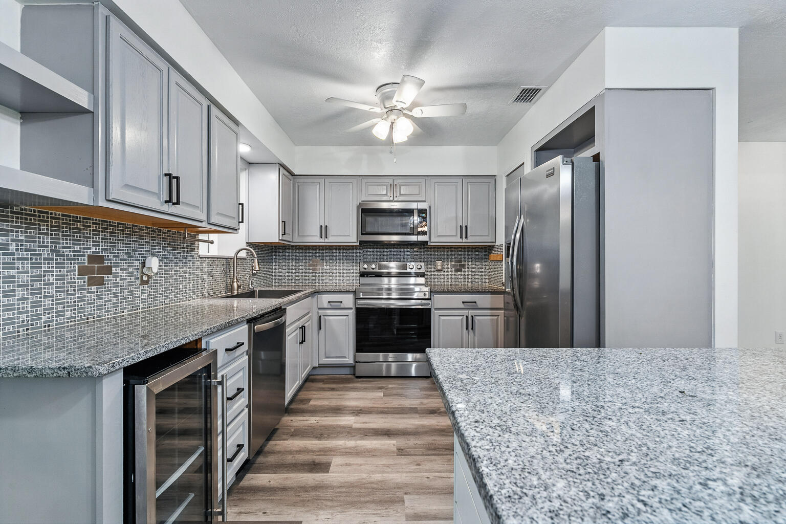 This beautifully updated Crestview home offers the perfect combination of comfort, style, and functionality, set on an acre of land. Mature landscaping surrounds the property with a vibrant row of azalea bushes along the perimeter and a stately magnolia tree in the front yard, providing natural privacy and timeless curb appeal. Inside, durable vinyl plank flooring flows seamlessly throughout, complementing a fresh, neutral color palette that creates a warm and inviting backdrop for any decor. The thoughtful layout includes a spacious living room, a formal dining room and a bonus room right off the kitchen with its own mini-split HVAC system. It offers endless flexibility, easily serving as an office, home gym, craft space, or guest suite. The heated and cooled bonus room further extends the living space, offering an ideal spot to relax and enjoy backyard views! There is also an additional space off the living room with a murphy bed that could also accommodate guests or serve as a fourth bedroom. The kitchen is a true centerpiece, designed for both beauty and practicality. Featuring gleaming granite countertops, a large center island, a wine and beverage cooler, and ample cabinetry, this space is perfect for cooking, entertaining, or gathering with family and friends. Recently updated appliances, including a microwave, range, and dishwasher (all approximately one year old), add to the home's modern convenience. The primary suite offers a generous walk-in closet and a private bath with a stylish vanity and glass-enclosed tub/shower combination, while the second bathroom is equally updated with modern finishes. Custom barn doors add character and versatility to the interior, while updated lighting throughout enhances its inviting atmosphere. Recent improvements include brand-new windows in the main area of the home with a transferable 30-year warranty, fresh interior paint, and updated ductwork, ensuring comfort and efficiency for years to come. A durable metal roof and an assumable 5% FHA mortgage option for qualified buyers make this home a truly unique opportunity. Outdoors, the property continues to impress with a fully fenced backyard, a large open patio, a workshop with a 50-amp RV outlet and a storage shed. NO HOA and the chicken coop adds a touch of country living, making this an ideal property for those who enjoy sustainable lifestyles or hobby farming. The long driveway provides ample parking for multiple vehicles, RVs, or recreational equipment, and the home is already wired with a generator hookup and transfer switch for added peace of mind! Located just minutes from Crestview's shopping, dining, and schools, this home offers a rare combination of thoughtful design, practical amenities, and over $30,000 in recent upgrades. With its stunning kitchen, versatile spaces, and beautifully landscaped acre, this property is a must-see for buyers seeking both style and functionality. Schedule your showing today!
*Note: Some photos have been virtually staged*