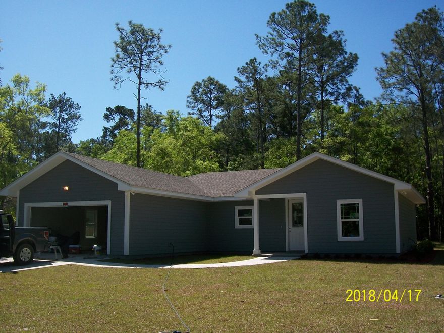 Custom, classic home in Freeport without HOA. This 3/2 home is full of upgrades from shaker cabinets and interior doors, to custom crown molding throughout. The super plan features clean, open kitchen with counter top bar that opens into the living room which then opens into the back yard / deck. The master suite has a large master bath with walk in shower as well as a tub and double solid vanity. The walk in pantry has a custom barn door which slides shut. Upgraded shaker Forevermark cabinets with soft close feature. Laundry room has an oversized sink right inside the garage entry to allow for the messes to remain out of sight. The garage door and attic are insulated to keep the cool in. A back deck is available for enjoying the large yard. Measurements are approximate. Call and come see