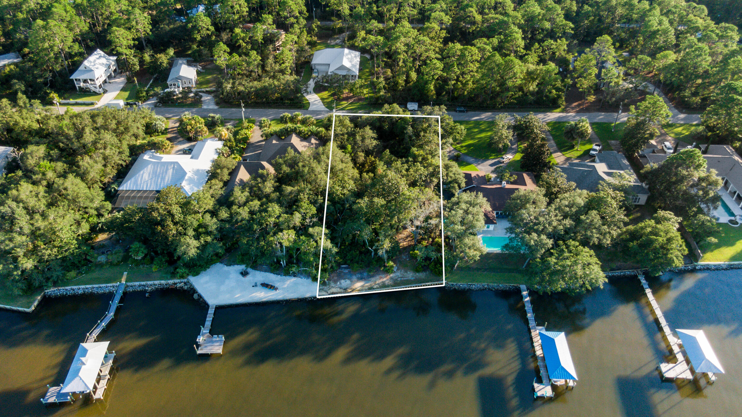 This beautiful bayfront lot has it all; enjoy breathtaking views of the Choctawhatchee Bay. Lot 12 in Hatchee Shores has 100 ft on the Choctawhatchee Bay with a NEW SEAWALL and DOCK in Place. Just minutes from 30A and the beaches of South Walton, located 1 1/2 miles from the 331 bridge on the quiet Nursery Road. Mature oaks give the appeal of Old Florida.  The Lot is 100 ft wide and 275 ft deep, with plenty of room to build your waterfront dream home. Spend your morning's kayaking or paddleboarding on the bay and your afternoons cruising the bay on the boat. The Lot offers one of the highest elevations and is situated within an X Flood Zone. It is close enough to Grayton Beach, Seaside, and WaterColor to take advantage of the restaurants and activities.