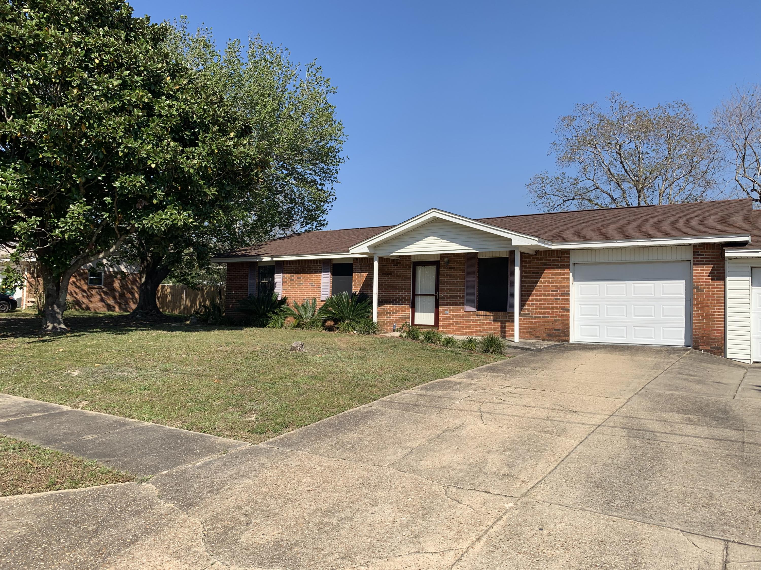 Fantastic location for this 3 bedroom, 2 bath one-story home. Found in the heart of Destin, this home has had some updates over the years to include roof (2017), new dishwasher, and kitchen refresh. Huge great room with cathedral ceilings with built-in shelves and a wood burning fireplace that leads to an enclosed FL room. The large fenced in backyard has a workshop plus garage space for potentially two cars and an oversized driveway to accommodate a boat or extra vehicles. This home has been a rental for several years and is being sold in AS-IS condition. If you are looking to be literally minutes from the Destin Harbor, without an HOA this homes is a definite must see.