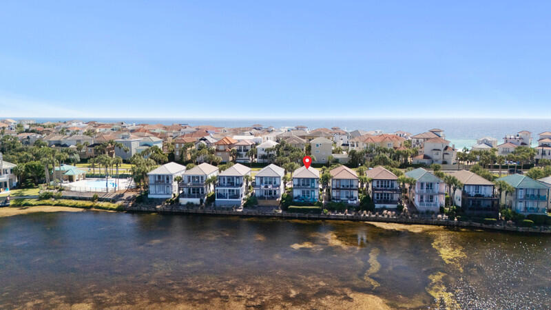Destiny Beach Villas rock!! Two fully furnished 2 bedroom/2 full bath rental units on Scenic Hwy 98 - just steps away from popular Crystal Beach. Each unit is fully furnished and sleeps 8 people. Recent improvements include back deck furniture 2024, new king size mattresses 2024, new floors and kitchen cabinets in down unit 2024. Back yard is Four Prong Lake with lots of nature - fish, ducks and turtles. Extended paver deck on down unit for barbecue.Everything is near by - shopping and recreation. Large community pool for owners and rental guests. A totally relaxing property on a lake. Walking access over and under Scenic Hwy 98 to Destin's white sand beaches!!! Each unit has 2 assigned parking spaces with added guest parking. A top investment opportunity on the Emerald Coast.