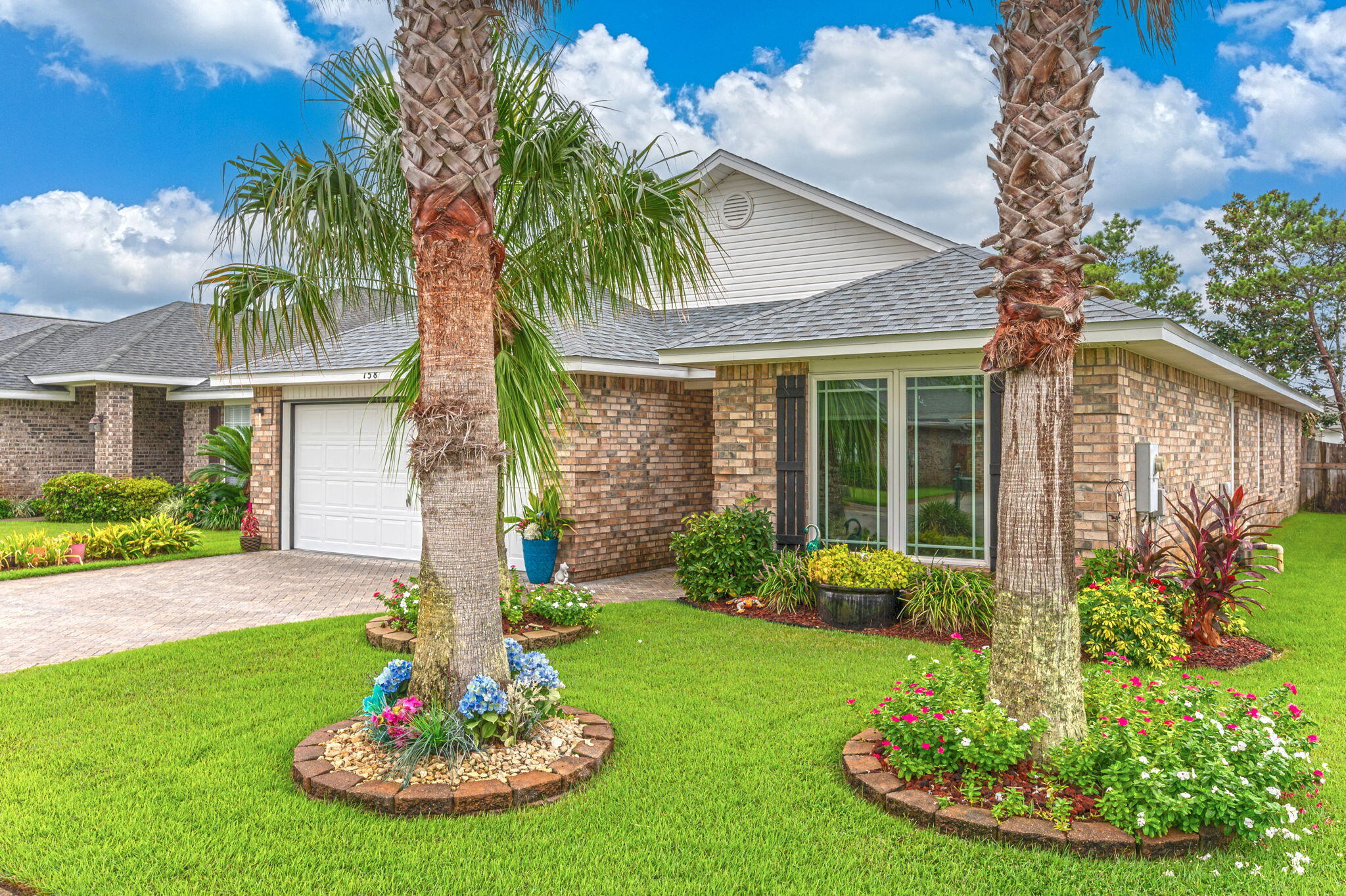 From the moment you enter this beautiful home you'll notice the many quality upgrades and thoughtful details that have been added to enhance the value and ambiance that sets it apart from the rest! Located just yards from the sugar white sands of the Emerald Coast, the community of Paradise Retreat offers 320 feet of deeded beach access for the enjoyment of its residents and guests. Your options are limitless with opportunities to use this piece of paradise as your primary home, secondary home or an income producing property via long or short term rentals. The home has been meticulously maintained and pride of ownership is evident. You'll notice curb appeal galore from the beautiful tropical landscaping and sod (2017), new roof (2023) new front and back doors (2024), brick paver driveway and front entrance (2016) and an expanded back patio in the fully fenced backyard. New high impact casement windows were installed in 2019. Casement windows are hinged on the side and crank outward to open like a door. Let that fresh air in with ease. No more struggling to open a double hung window! Never run out of hot water for yourself or your guests with a Rinnai tankless hot water heater (2018)  A new HVAC system was installed in 2018 as well. Thoughtful upgrades were also added to the interior including crown molding throughout the home, stacked stone accents in the living room and dining room, a beautiful new tile shower and whirlpool tub in the master bedroom, new tile shower in the guest bathroom, new ceiling fans in the living room and guest bedroom, new stainless electric range and refrigerator (ice maker is not warranted) in the kitchen (2016) as well as tile backsplash and accents as well as fresh paint in many of the rooms. Paradise Retreat is uniquely situated directly between Highway 98 and Scenic Gulf Dr, which provides both north and south entrances/exit for the community. Come take a look at this one of a kind property that checks all the boxes!






