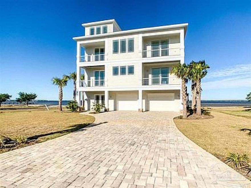 Don't miss out on your chance to own this one-of-a-kind, executive waterfront home located on the beautiful Perdido Bay. There are only 8 lots tucked away in this small private, gated community. This home offers magnificent views and breathtaking sunsets from multiple rooms and balconies throughout. Never miss out on gatherings with your family or while entertaining guest with the open kitchen/living room concept. Kitchen offers a large island, beautiful white cabinetry, quartz counter tops and a separate pantry. Master Suite offers double sliding doors that lead out to your very own private balcony that overlooks the gorgeous Perdido Bay. Two master closets as you enter the master bath, double sinks, and oversized shower with multiple shower heads. Endless hot water provided by tankless w