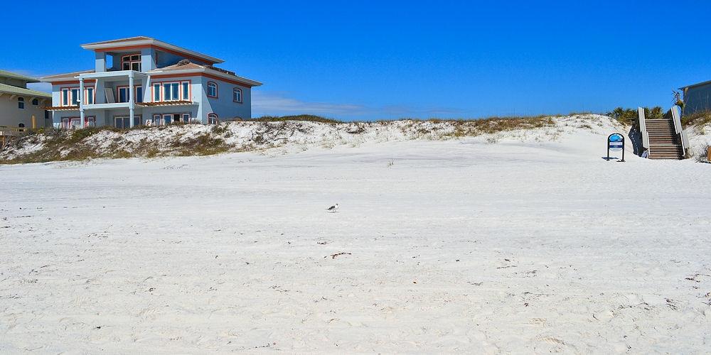 Currently lowest priced Gulf-front vacant lot in Santa Rosa Beach! This is buildable Gulf-front residential home site is located in a beautiful low density coastal community consisting of only four total parcels... and the other three parcels have Gulf-front homes making this the last and only vacant lot left in the community! The most recent home constructed in this community received approval for additional land fill with a retention wall which significantly extended the size of the buildable lot! Enter this private gated community via a cobblestone street adorned with tropical landscaping as you approach the Gulf of Mexico, and the vacant lot is the furthest east end parcel in the community!