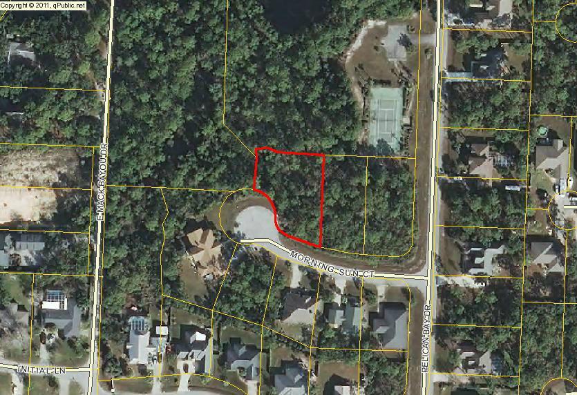 Dreaming of a building on the Emerald Coast? Look at this private, wooded lot on a cul-de-sac with conservancy area at the rear in the convenient, waterfront, gated community of Pelican Bay Terrific neighborhood amenities include gated entry, tennis, deeded Bay access including picnic area and dock. Paved streets & utilities available. Ideal location to enjoy the beach, bayou boat lauches to both the Bay and Gulf,shopping, dining, championship golf courses, and close to hospital facilities. Flood zone of AE. Measurements are from the property appraiser and should be verified to Buyers satisfaction