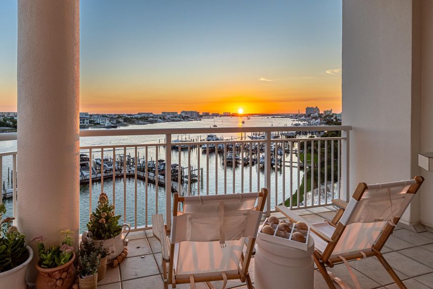 Where Coastal Luxury Meets Everyday Life! Grand Harbor Unit 410 is an east-end 4BR/4BA corner residence redefining Destin waterfront living. Panoramic views of the lagoon, Destin Harbor & Gulf of America set the stage for sunrises, sunsets & fireworks. Renovated with 9.5-ft ceilings, 9'' White Oak flooring, custom coastal trim, oil-rubbed bronze hardware, shiplap, gas fireplace, lounge area & guest suite. Chef's kitchen offers quartz counters, Bosch French door fridge, ZLINE 36'' 6-burner gas range, microwave drawer & pantry with custom wood shelving. Dual walk-in closets & spa bath with concrete vessel sinks, polished nickel fixtures, walk-in shower & freestanding tub overlook the harbor. Enjoy over 300 sq. ft. of balcony space and a heated waterfront pool with hot tub. Each guest bath has been remodeled with designer tile, new vanities, and upgraded fixtures. Grand Harbor is a rental-restricted, gated community offering a private marina with under-dock storage for paddleboards and kayaks, and a newly renovated lobby with fireplace, lounge area, and a private amenity suite for your extra guests. Lush landscaping frames the gated entry and leads to a new state-of-the-art dog park where owners and their furry friends gather each afternoon for "Yappy Hour." With a 65-ft-wide floor plan and every single room offering a harbor view, you truly feel as though you are living in a home within a building. Take the water taxi to nearby restaurants or simply relax and soak in the view  Grand Harbor Unit 410 delivers Destin's ultimate waterfront lifestyle