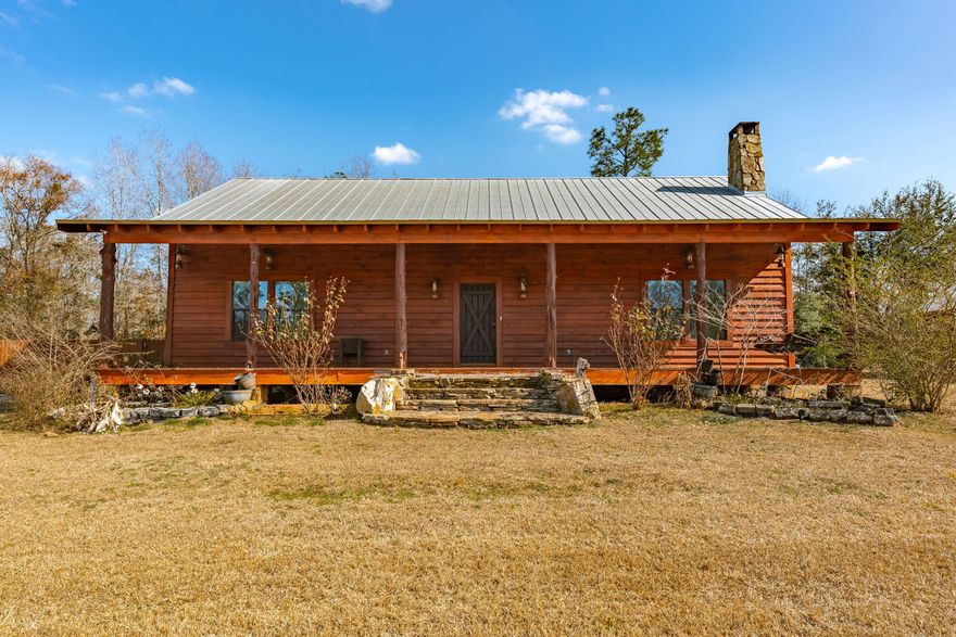 CURRENTLY UNDER CONTRACT; SELLER WILL CONSIDER BACKUP OFFERS Discover the rare opportunity to own an authentic log cabin on nearly 6 acres of beautiful land in Chipley, Florida. This home provides a serene retreat with ultimate privacy, perfect for the outdoor enthusiast. It includes 2 full bedrooms, one and a half bathrooms, and an additional loft area upstairs, suitable for a third bedroom or storage. As you enter, you will instantly notice the hardwood flooring throughout, rustic lighting fixtures, floor to ceiling stone-woodburning fireplace, tongue & groove vaulted ceilings, and recessed lighting in the living room. The open concept floor plan features a kitchen that contains a large island, custom wood cabinets and pantry, and stainless-steel appliances.

The one-of-a-kind wood dining table conveys with the sale. There is a washer and dryer and an additional refrigerator in the laundry room that will all convey with the sale as well as a deep freezer that will remain with the property. 

The primary bedroom is spacious and contains a large walk-in closet and electric fireplace. The ensuite bathroom features a double vanity, stone shower matching the wood burning fireplace in the living room, and large soaking tub. 

The front porch is massive, measuring approximately 50' x 8, which allows ample room for rocking chairs and the opportunity to enjoy sunsets on the front porch swing. This gem of a property is fully equipped with a Generac Generator ideal for power outages, and includes a double carport with additional attic storage, a large back deck area, and a powered workshop. 

The property is expansive enough for hunting white-tail deer during the season and has the potential to establish a shooting range for the sportsman. This property offers a blend of rustic charm and modern conveniences, making it an ideal home for outdoor enthusiasts. With this location, you are only a short 6-minute drive to Walmart Supercenter, Blue Lake Park (Earl Gilbert Landing), and various restaurant opportunities. Don't miss out on the chance to own this gem in Chipley, Florida.