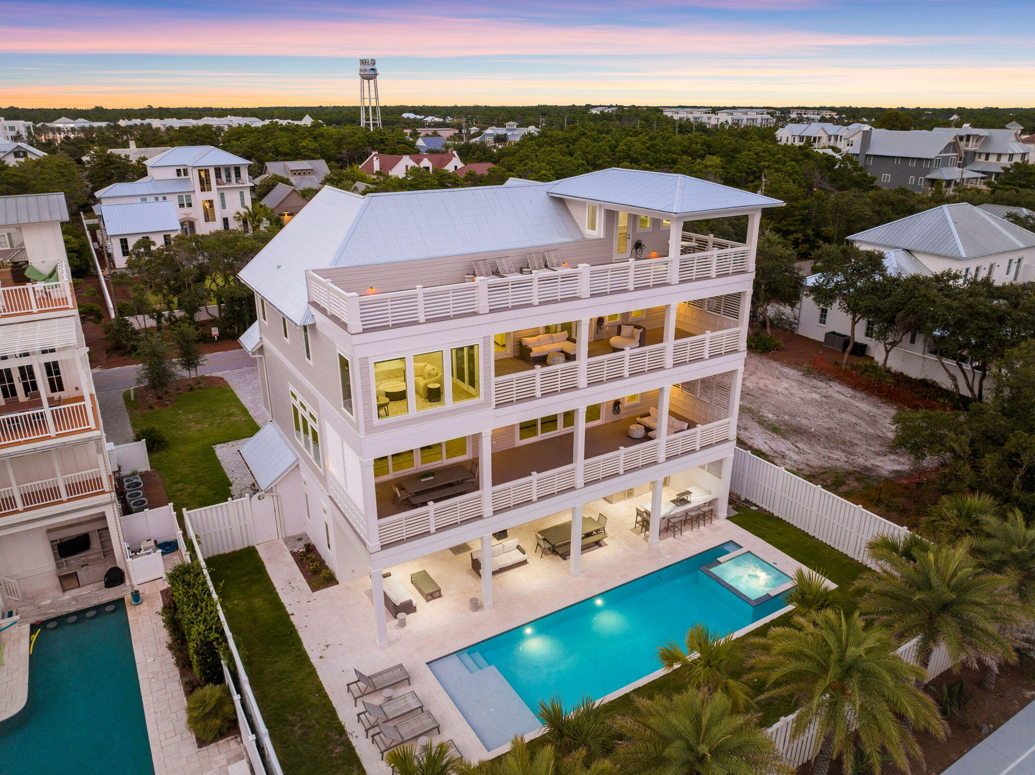 Welcome to your dream coastal oasis just steps from the shops and dining at Rosemary Beach and the friendly beach accesses in Inlet Beach. This magnificent 8-bedroom, 8-bathroom, and 2 half-bath residence spans an impressive 6,064 square feet of pure luxury living on a quarter of an acre. This home offers the perfect blend of tranquility and convenience.One of the standout features of this property is its stunning 50-foot heated pool and spa, creating an immediate sense of relaxation and entertainment. As you drive up, the curb appeal is enhanced by a spacious 2-car garage, providing ample parking and convenience for you and your guests.For those who love to entertain, the outdoor kitchen and bar complete with both a flat top and standard gas grill is a highlight.