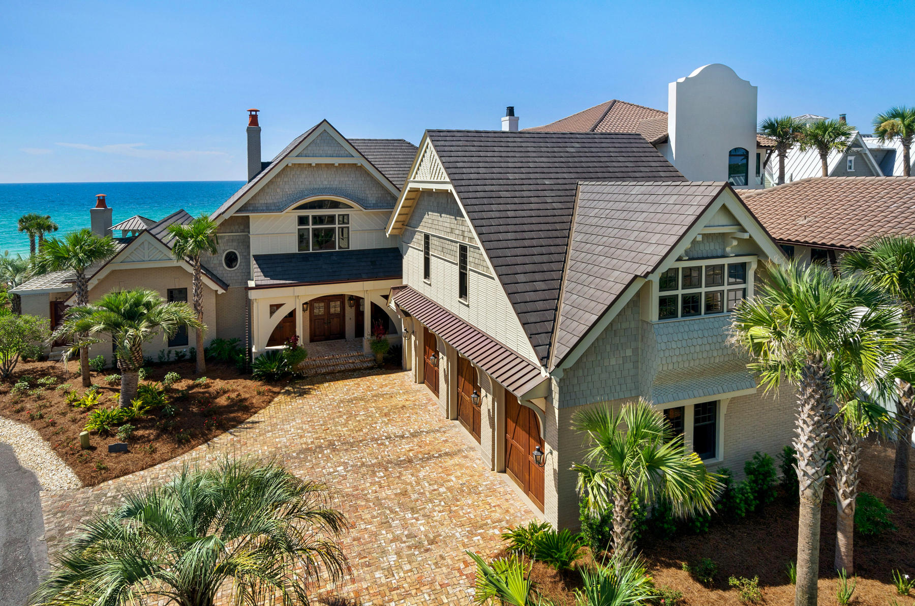 Presiding over 116 ft. of Gulf front this Seagrove residence embraces the essence of its surroundings with dramatic views from all angles. Expansive bifold glass doors stylishly and effortlessly open the living areas to the stone cover loggia and pool. On the loggia the stage is set for lounging by the infinity edge salt water pool, casual dining, or enjoying conversation around the fireplace and outdoor kitchen. Cleverly designed Jersusalem stepping stones over the pool lead to a more intimate raised hot tub with its own fireplace. Bevolo French Quarter gas lanterns add the finishing touch and ambiance to the outdoor living spaces. Cypress beams accentuate the main floor ceilings along with custom distressed cabinetry and an antique brick Rumford fireplace. When entertaining is a high