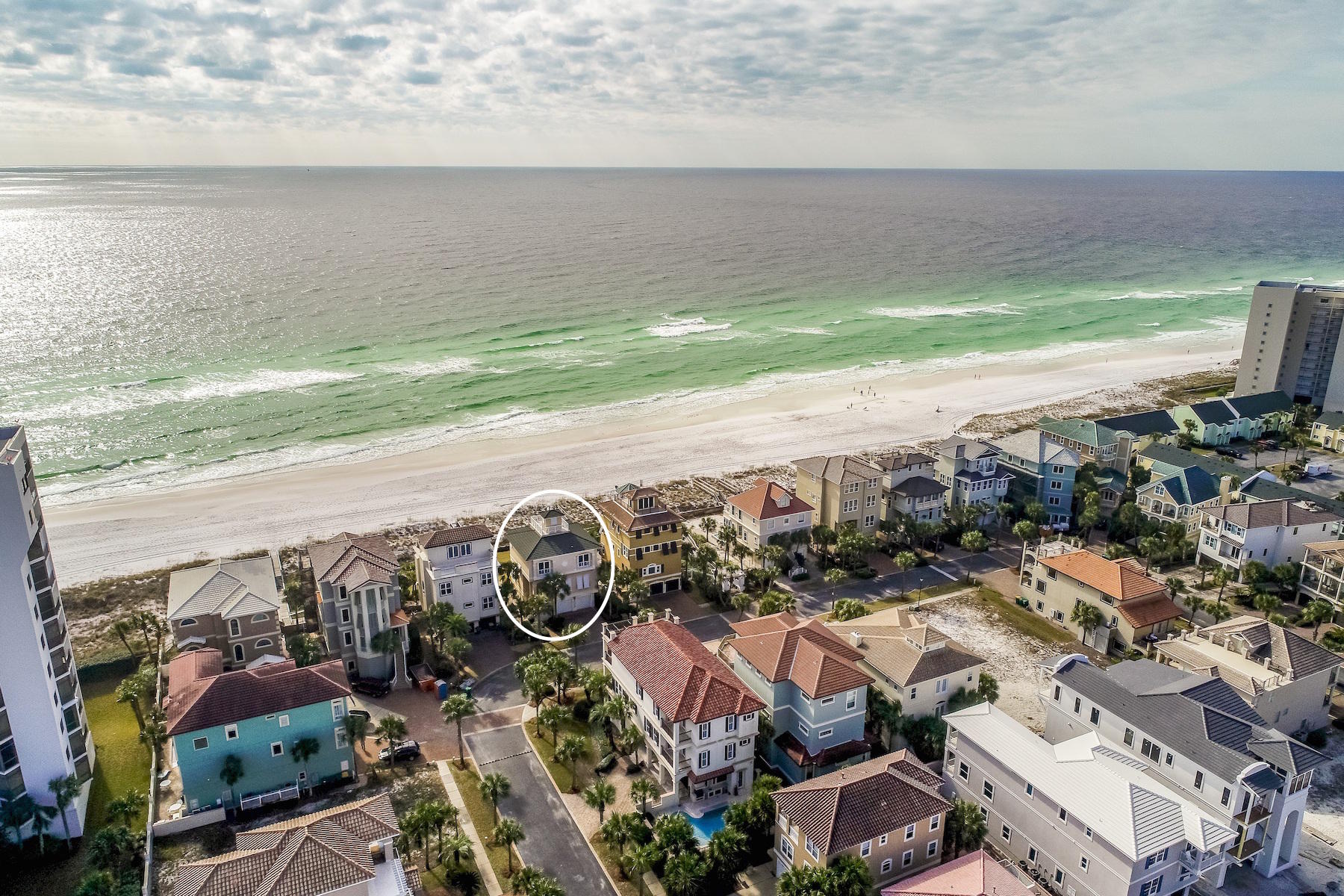 Sweeping views abound from this prominently located beachfront residence strategically positioned on a generously proportioned lot offering a rare private sodded backyard tucked away in the exclusive gated enclave of Dunes of Destin. A pristine retreat, this well maintained home would be the perfect secondary residence or short term rental offering an abundance of space with an idealistic open floorplan taking full advantage of the unobstructed vistas over the Gulf of Mexico. The epicenter of the living area is masterfully located on the second floor characterized by a 10' ceiling height and framed by a wall of windows overlooking the private beachfront. The spacious chef's kitchen is complete with granite countertops and stainless appliances while also offering ample cabinet storage as
