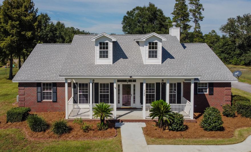 Your Peaceful 1-Acre Retreat - Just Minutes from Town. This all-brick, custom-built 3BR/2BA home sits on a nicely landscaped 1-acre lot in the Sand Hills of Northern Bay County and offers the perfect blend of comfort, function, and country charm. Lovingly maintained by its original owner, this property is loaded with thoughtful details inside and out. Step inside to find a spacious great room with a cozy fireplace and newer plank flooring, a bright kitchen with island and breakfast nook, and an oversized laundry room with a huge wall to wall pantry you'll love. The large primary suite features two walk-in closets and a large double vanity, providing plenty of space to spread out. Outside, enjoy peaceful mornings on the lovely back or front porch overlooking the fenced yard. The property  is equipped with an auto-opening front gate, sprinkler system, two sheds, and an oversized 2-car carport with attached storage/workshopideal for projects, hobbies, or extra storage. The owner once cultivated a thriving garden here, making this a wonderful option for food-to-table living. With County zoning, you can even bring your chickens! Tucked away on a paved road yet still convenient to town, this property offers the best of both worldsspace, privacy, and freedom. A true must-see for anyone seeking a well-built home with room to live, grow, and enjoy. (All sizes approximate and taken from public records, buyer to verify any details buyer deems important)
