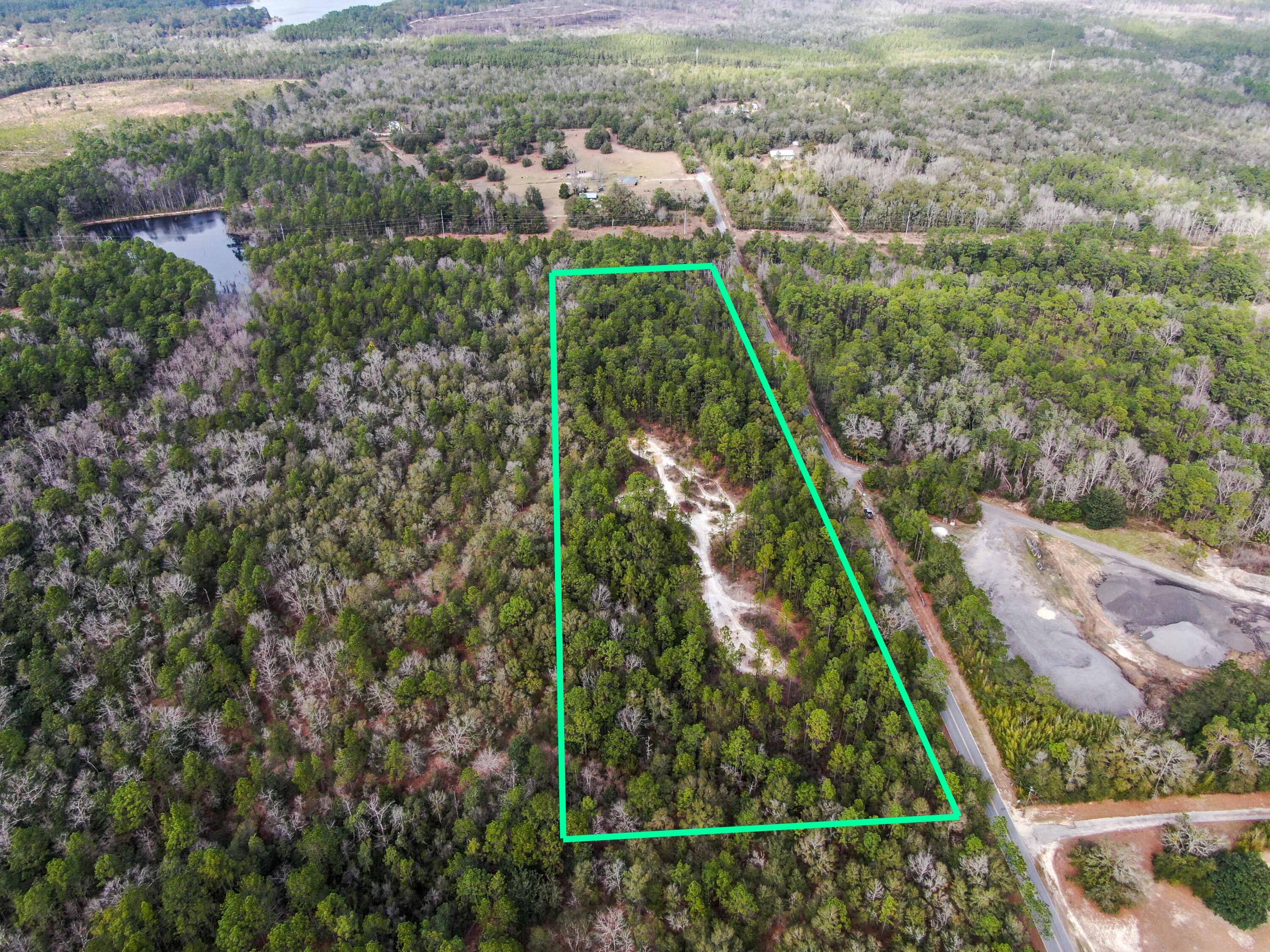 Incredible opportunity to own 10 gently rolling acres in NW FL, zoned Rural Village (2 units/homes per acre). Old FL terrain lw/ excellent location, just outside the city limits east of DeFuniak Springs. 250+ ft above sea level. Parcel is surrounded by larger parcels on all sides. A portion of the middle to north side was once used as a borrow pit. The county GIS website shows it as all uplands - pics show a small area on the NE corner that contains a wet area. Build your dream home or get creative with the rural village zoning! Possibilities include homes, multi-family, parks, civic or agricultural uses, as well as neighborhood commercial use. 30 minutes to the beaches of South Walton! Close to Elgin Base. There are no utilities in place with electric available at the road.