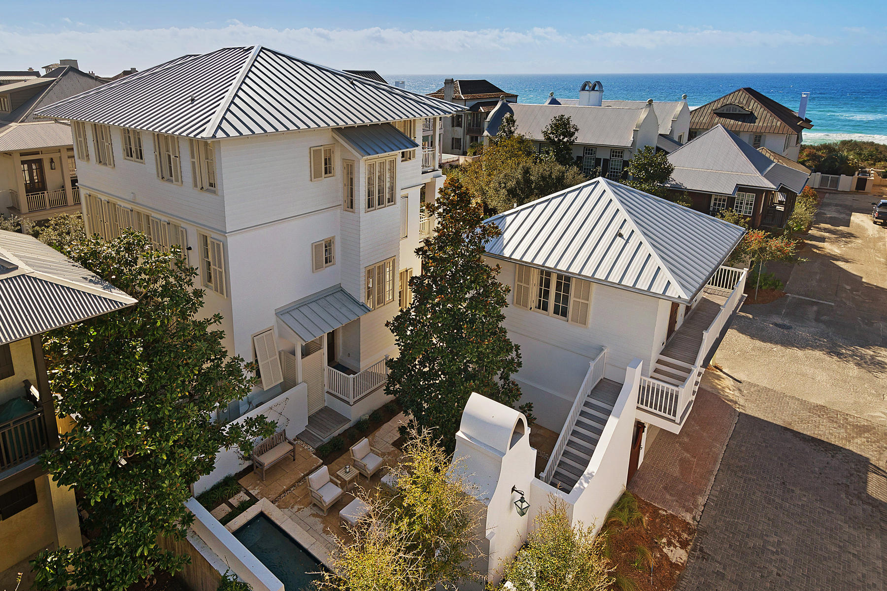 Experience life in Rosemary Beach as only a few can in this recently renovated gulf view home and carriage house, south of Scenic Highway 30A, and only a stone's throw from the trend-setting shops and divine dining establishments along this famed new urban town's Main Street. Located directly on a beach boardwalk, the home's position takes advantage of unusually wide setbacks of the homes immediately across the street along the waterfront. This unique scenario affords its third floor living spaces panoramic views of the Gulf of Mexico's emerald waters. A thorough renovation of the outdoor courtyard space includes a striking outdoor fireplace, outdoor shower, and dipping pool with fountain.