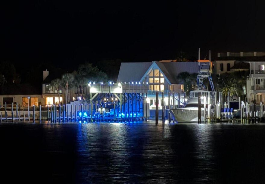 LIST PRICE SIGNIFICANTLY REDUCED! EXTRAORDINARY, DEEP-WATER, YACHTSMAN'S & SPORTSFISHERMAN'S WATER-FRONT ESTATE oriented on Destin, Florida's Scenic Harbor.  Located within the legendary enclave of Holiday Isle, this exclusive address is the only harbor-front estate currently offered for sale and rarely do like-kind opportunities arise on the South side of the gorgeous Harbor due to such a limited density of lots fronting the harbor. Holiday Isle is unique in that it offers dedicated beach access for its ownership and their guests, which is afforded through very reasonable dues, currently $495.00/annually.  An estate of this caliber and distinction should be viewed as a generational ownership opportunity, as the phenomenal lifestyle it offers is unrivaled anywhere along the Emerald Coast on the Gulf of America.  This property has been beautifully renovated and newly decorated and is being offered turnkey; fully furnished and accessorized with all audio and video.  The dock structure and its features are irreplaceable; "grandfathered" specifications, thus providing an instant solution to moor and lift your boats, yachts, skid for jet skis, paddleboards, tackle/storage room, motorized catch lift and guided aluminum rails to the fish cleaning station, and a magnificent rooftop sunbathing  and stargazing terrace atop two of the covered slips; all accessible directly from your private backyard, which includes an expansive heated pool.  The hardscaping, landscaping, and ambient exterior and dock lighting accentuate the distinctive roof and dock elevations. Quite a scope of improvements have recently been completed, including but not limited to the following: (2) natural gas Rinnai tankless hot water heaters that supply the entire house; all recessed lights throughout were replaced with efficient LED technology; entire interior repainted including all new moldings; exterior deck painted and sealed; all exterior railings painted; new insulated, modernized garage doors and openers; AquaLink technology that allows for control of the pool functions via smartphone app; Control 4 home automation app also interfaces with the TV's.  (2) new Trane A/C units installed; while all four units have new Trane thermostats controlled remotely via app; oversized double floating jet dock installed; (7) high resolution digital home surveillance cameras with cloud-based NVR; (4) boat dock Luma surveillance cameras.  Wi-Fi module added to the Generac whole house generator allowing for interface with a smartphone app as well. The most extraordinary dock, slips, boathouse, and boathouse rooftop terrace on Holiday Isle with spectacular view corridor of the scenic harbor and fabulous sunsets.  Please inquire for further details and to schedule a private showing.