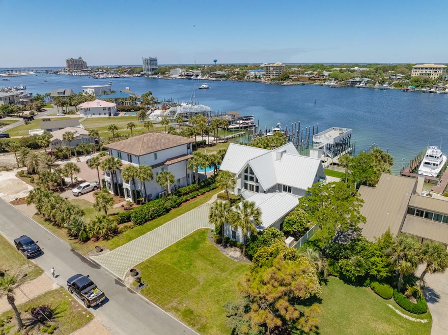 LIST PRICE SIGNIFICANTLY REDUCED! EXTRAORDINARY, DEEP-WATER, YACHTSMAN'S & SPORTSFISHERMAN'S WATER-FRONT ESTATE oriented on Destin, Florida's Scenic Harbor.  Located within the legendary enclave of Holiday Isle, this exclusive address is the only harbor-front estate currently offered for sale and rarely do like-kind opportunities arise on the South side of the gorgeous Harbor due to such a limited density of lots fronting the harbor. Holiday Isle is unique in that it offers dedicated beach access for its ownership and their guests, which is afforded through very reasonable dues, currently $495.00/annually.  An estate of this caliber and distinction should be viewed as a generational ownership opportunity, as the phenomenal lifestyle it offers is unrivaled anywhere along the Emerald Coast on the Gulf of America.  This property has been beautifully renovated and newly decorated and is being offered turnkey; fully furnished and accessorized with all audio and video.  The dock structure and its features are irreplaceable; "grandfathered" specifications, thus providing an instant solution to moor and lift your boats, yachts, skid for jet skis, paddleboards, tackle/storage room, motorized catch lift and guided aluminum rails to the fish cleaning station, and a magnificent rooftop sunbathing  and stargazing terrace atop two of the covered slips; all accessible directly from your private backyard, which includes an expansive heated pool.  The hardscaping, landscaping, and ambient exterior and dock lighting accentuate the distinctive roof and dock elevations. Quite a scope of improvements have recently been completed, including but not limited to the following: (2) natural gas Rinnai tankless hot water heaters that supply the entire house; all recessed lights throughout were replaced with efficient LED technology; entire interior repainted including all new moldings; exterior deck painted and sealed; all exterior railings painted; new insulated, modernized garage doors and openers; AquaLink technology that allows for control of the pool functions via smartphone app; Control 4 home automation app also interfaces with the TV's.  (2) new Trane A/C units installed; while all four units have new Trane thermostats controlled remotely via app; oversized double floating jet dock installed; (7) high resolution digital home surveillance cameras with cloud-based NVR; (4) boat dock Luma surveillance cameras.  Wi-Fi module added to the Generac whole house generator allowing for interface with a smartphone app as well. The most extraordinary dock, slips, boathouse, and boathouse rooftop terrace on Holiday Isle with spectacular view corridor of the scenic harbor and fabulous sunsets.  Please inquire for further details and to schedule a private showing.
