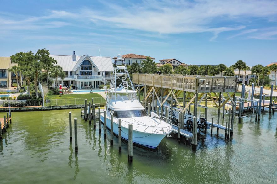 EXTRAORDINARY, DEEP-WATER, YACHTSMAN'S & SPORTSFISHERMAN'S WATER-FRONT ESTATE oriented on Destin, Florida's Scenic Harbor.  Located within the legendary enclave of Holiday Isle, this exclusive address is the only harbor-front estate currently offered for sale and rarely do like-kind opportunities arise on the South side of the gorgeous Harbor due to such a limited density of lots fronting the harbor. Holiday Isle is unique in that it offers dedicated beach access for its ownership and their guests, which is afforded through very reasonable dues, currently $495.00/annually.  An estate of this caliber and distinction should be viewed as a generational ownership opportunity, as the phenomenal lifestyle it offers is unrivaled anywhere along the Emerald Coast on the... on the Gulf of America.  This property has been beautifully renovated and newly decorated and is being offered turnkey; fully furnished and accessorized with all audio and video.  The dock structure and its features are irreplaceable; "grandfathered" specifications, thus providing an instant solution to moor and lift your boats, yachts, skid for jet skis, paddleboards, tackle/storage room, motorized catch lift and guided aluminum rails to the fish cleaning station, and a magnificent rooftop sunbathing  and stargazing terrace atop two of the covered slips; all accessible directly from your private backyard, which includes an expansive heated pool.  The hardscaping, landscaping, and ambient exterior and dock lighting accentuate the distinctive roof and dock elevations. Quite a scope of improvements have recently been completed, including but not limited to the following: (2) natural gas Rinnai tankless hot water heaters that supply the entire house; all recessed lights throughout were replaced with efficient LED technology; entire interior repainted including all new moldings; exterior deck painted and sealed; all exterior railings painted; new insulated, modernized garage doors and openers; AquaLink technology that allows for control of the pool functions via smartphone app; Control 4 home automation app also interfaces with the TV's.  (2) new Trane A/C units installed; while all four units have new Trane thermostats controlled remotely via app; oversized double floating jet dock installed; (7) high resolution digital home surveillance cameras with cloud-based NVR; (4) boat dock Luma surveillance cameras.  Wi-Fi module added to the Generac whole house generator allowing for interface with a smartphone app as well. The most extraordinary dock, slips, boathouse, and boathouse rooftop terrace on Holiday Isle with spectacular view corridor of the scenic harbor and fabulous sunsets.  Please inquire for further details and to schedule a private showing.