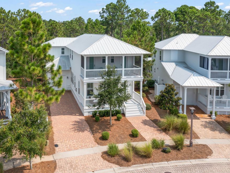 This beautiful home at NatureWalk has pleasing pond views in the front and a tree-lined rear providing ample privacy. Porches on both levels provide shady spaces for enjoying this tranquil setting. The welcoming front porch leads into a stunning open living room. Lustrous hardwood flooring, tall windows and white beams tie the home to its natural surroundings. A quartz fireplace adds a focal point to the bright sitting area. Beyond the dining room, the kitchen is equally inspiring with generous quartz countertops, a gas cooktop, ice machine and Shaker-style cabinets. Perch at the generous island bar and enjoy drinks, snacks and conversation with the chef. Stairs lead up to four generous bedrooms including a guest suite with its own private bathroom and two beautiful bedrooms with access to a screened balcony overlooking the pond. Where better to watch ducks and wildlife while planning your day with a cup of coffee? The master suite is another spacious sanctuary with a deep tray ceiling, walk-in closet and private porch with unspoiled views. A lengthy vanity, free-standing tub and glittering chandelier add a luxurious ambiance to the exquisite master bathroom. The home comes fully furnished with new exterior paint and an extended garage. A lengthy driveway can easily accommodate several vehicles. As well as enjoying its natural environment, this pristine beach home is close to the zero-entry community pool, beach trail and bike rides. The Gathering Place is a friendly hub in the community with heated lap pool, hot tub and fire pit. There's a good choice of shopping and dining nearby at Seaside, Florida, when you're not spending happy days on the powder-soft sands of Seagrove Beach.