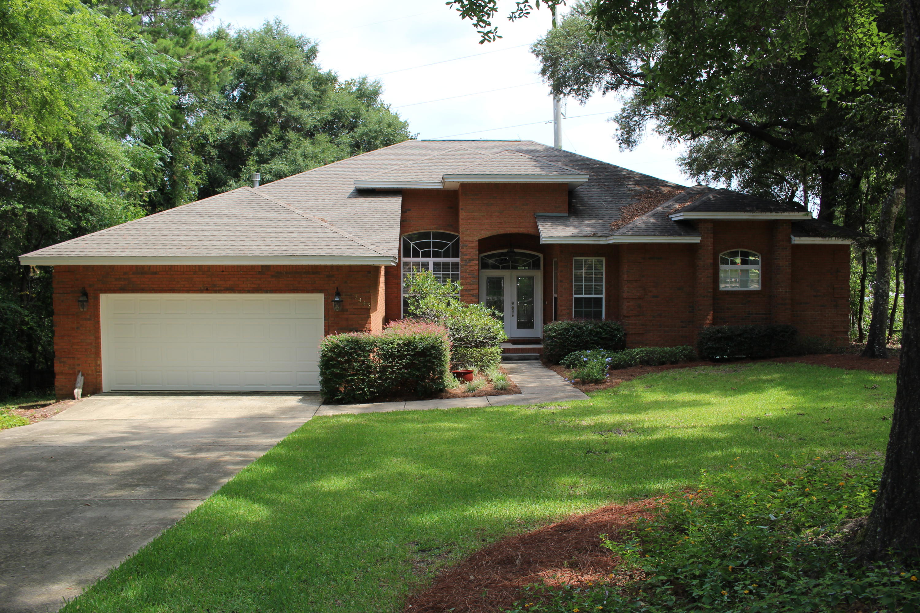 Situated on half an acre, this home is located in a quiet neighborhood with no thru traffic. As you enter this home you are greeted with an open, flowing floor plan complemented by split bedrooms for ultimate privacy. Travertine flooring, crown molding, and beautiful light fixtures are in the foyer, formal dining room, and great room. Your first room is off to your right with a pocket door to the hall bathroom. This is the perfect sized room for an office or den space. The master bedroom is on this side of the home complete with massive his-and-her closets, linen closet, Jacuzzi tub, separate shower, private water closet, and double vanity sinks. Back out into the