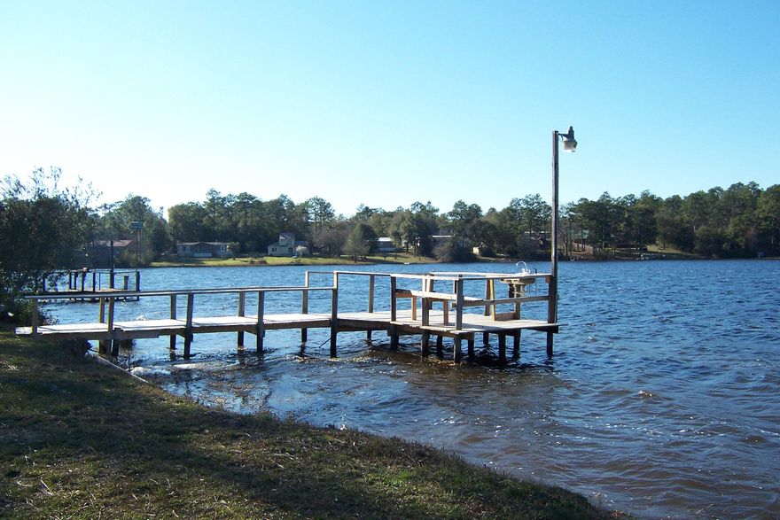 This large home is situated in a quite cul de sac right on beautiful king lake with an amazing view and large waterfront lot. Home offers a large open living room with fireplace, great size dining room and kitchen with tons of relaxing views from every angle of the home. Tons of kitchen space with cabinets, island and counter space makes for great entertaining plus 2 large pantries. Home offers large master, 2 additional bedrooms on a split floor plan, 2 utility rooms, 2 hvac units, additional 4th bedroom or office space plus tons of outdoor living space. Great screened in back porch perfect for afternoons, nice new dock for fishing, detached 2 car carport and tons of yard space. Home offers over 2000 sqft and 140 feet on the water! Great place to call your new home