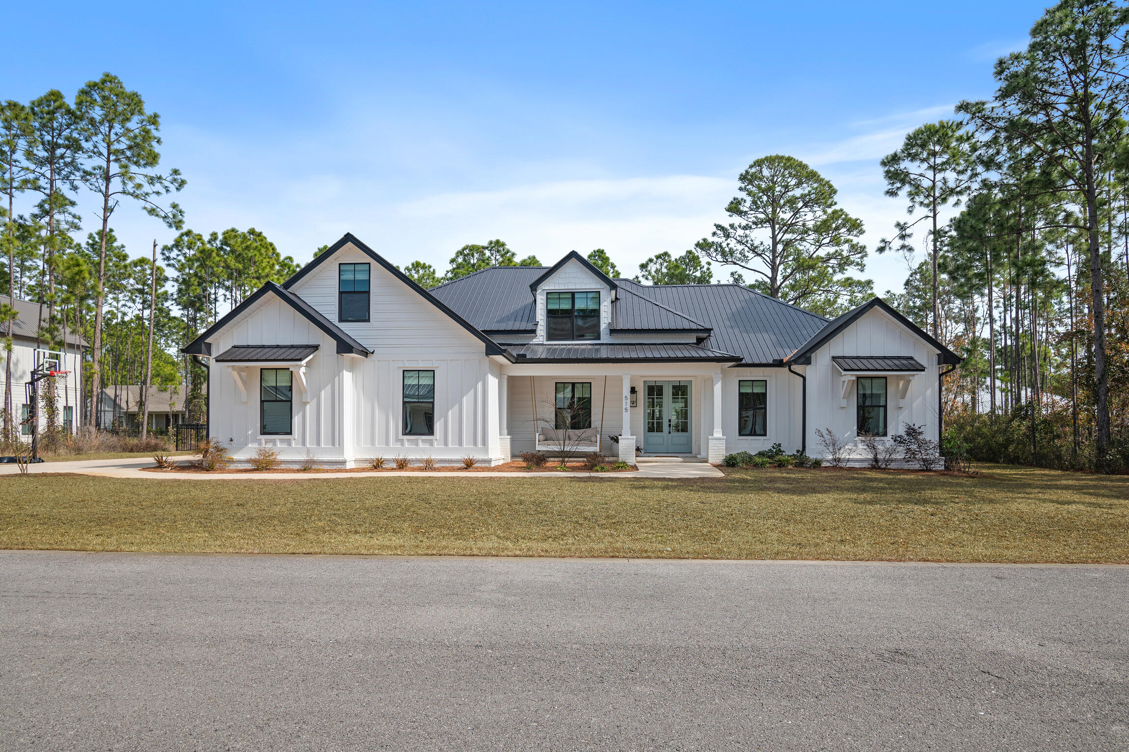 Welcome to this exquisite semi-custom home in the desirable Seclusion Bay community. This residence blends coastal elegance with traditional charm, featuring an open floor plan in calming tones. The chef's kitchen boasts quartz countertops, stainless steel appliances, and a walk-in pantry. The expansive primary suite includes two walk-in closets and a luxurious bathroom with a walk-in shower and soaking tub. The main level offers two additional bedrooms, a full bath, a versatile office/flex space, a powder room, and a large laundry room. Upstairs, a fourth bedroom with an en-suite bathroom and bonus area awaits guests. Outside, enjoy a private oasis with a heated pool and spacious patio, complete with automatic screens for year-round comfort.