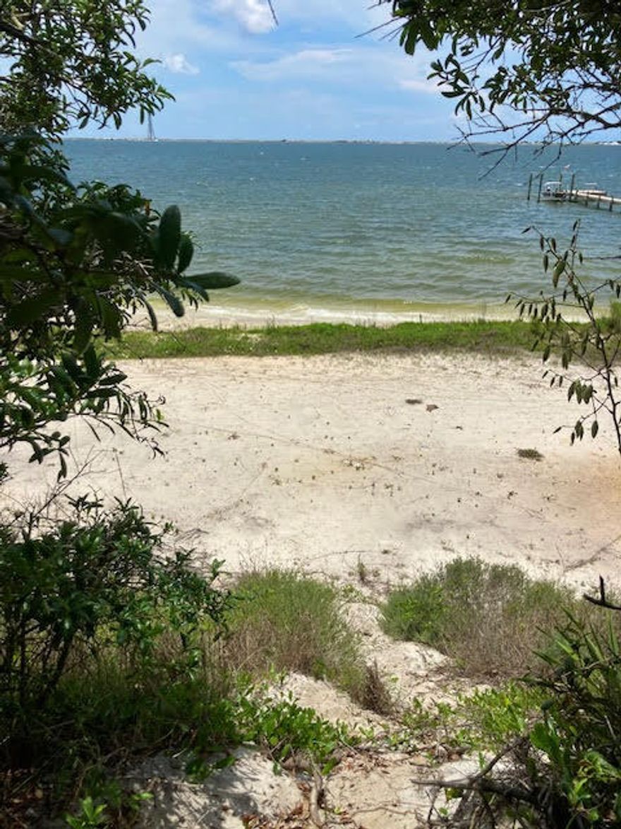 HALF ACRE Wooded WATERFRONT lot on the SANTA ROSA SOUND with natural shore and sandy beach. Waterfront is 13 feet below the street level.BUILD a PIER to fish and launch your boat to motor EAST to DESTIN or WEST to PENSACOLA.IMAGINE YOUR OWN PIECE OF PARADISE ON THE EMERALD COAST.INSULATED CONCRETE FORM or HEBEL CONSTRUCTION ARE the PERFECT CHOICE FOR a structurally sound home on the coast. Located across from the barrier island with the GULF beyond.